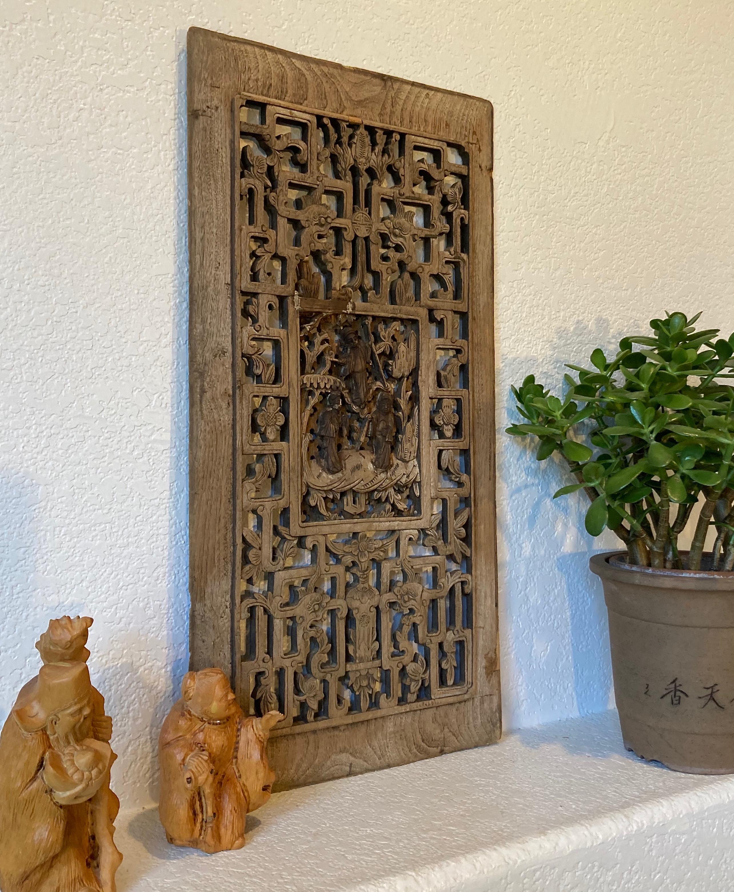 Unframed panel, hand carved from a solid piece of wood. Rectangular center carving with personage, dragon, bat and floral motifs.