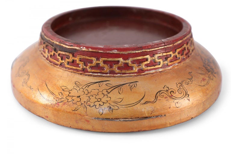 Antique Chinese circular wooden box with carved top character design and carved geometric foot, painted in gold and red with a fitted lid and fine black painted border pattern.
   