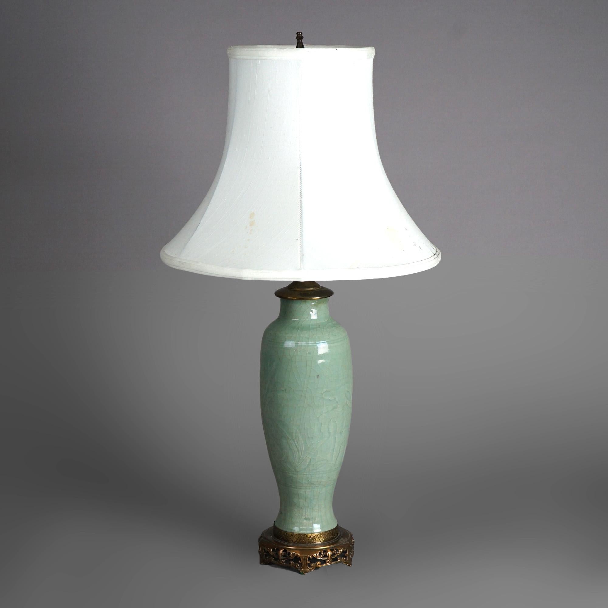 An antique table lamp offers Chinese art pottery vase with embossed foliate decoration and crazed celedon glazing, c1930

Measures - 27
