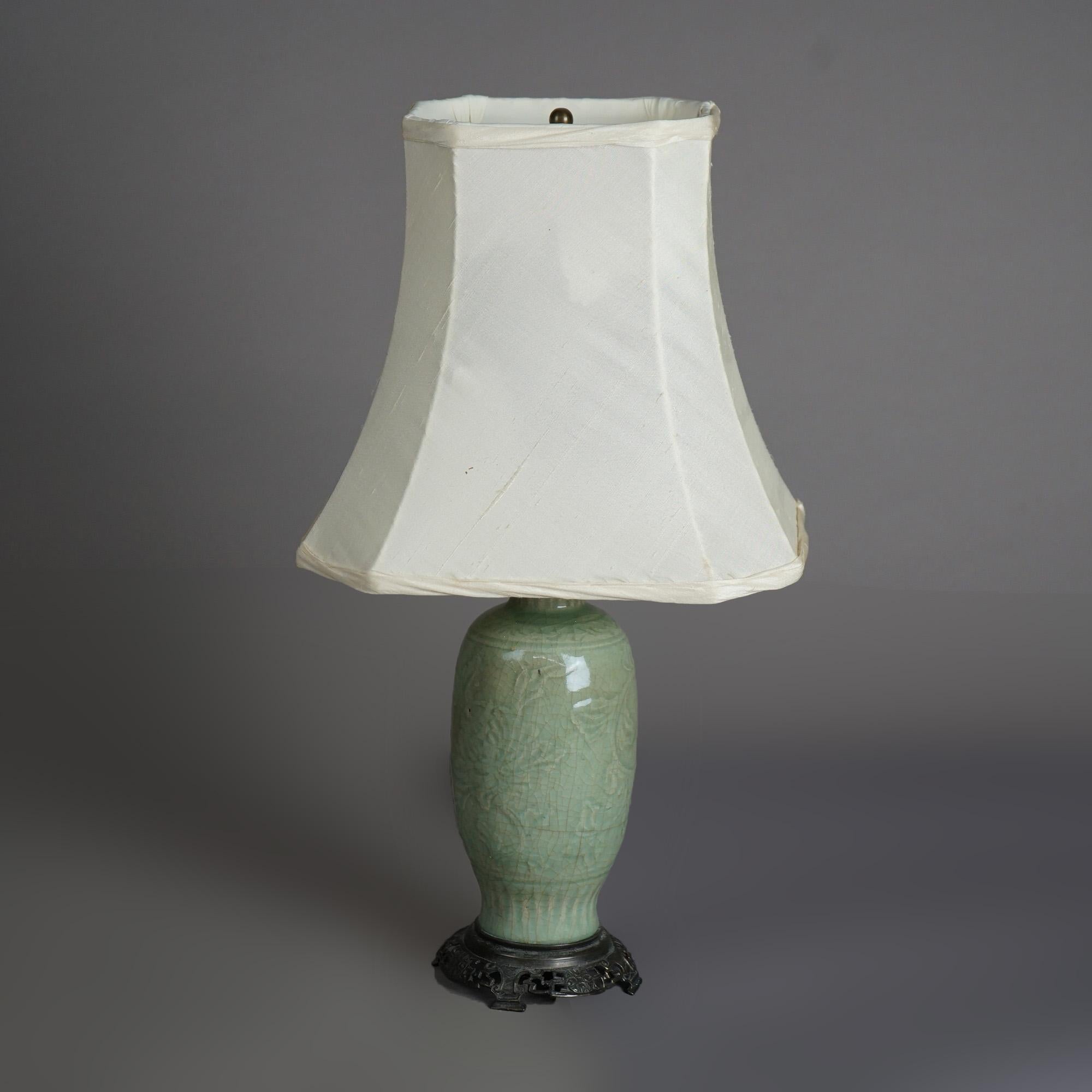 An antique table lamp offers Chinese art pottery vase with embossed foliate decoration and crazed celedon glazing, c1930

Measures - 18