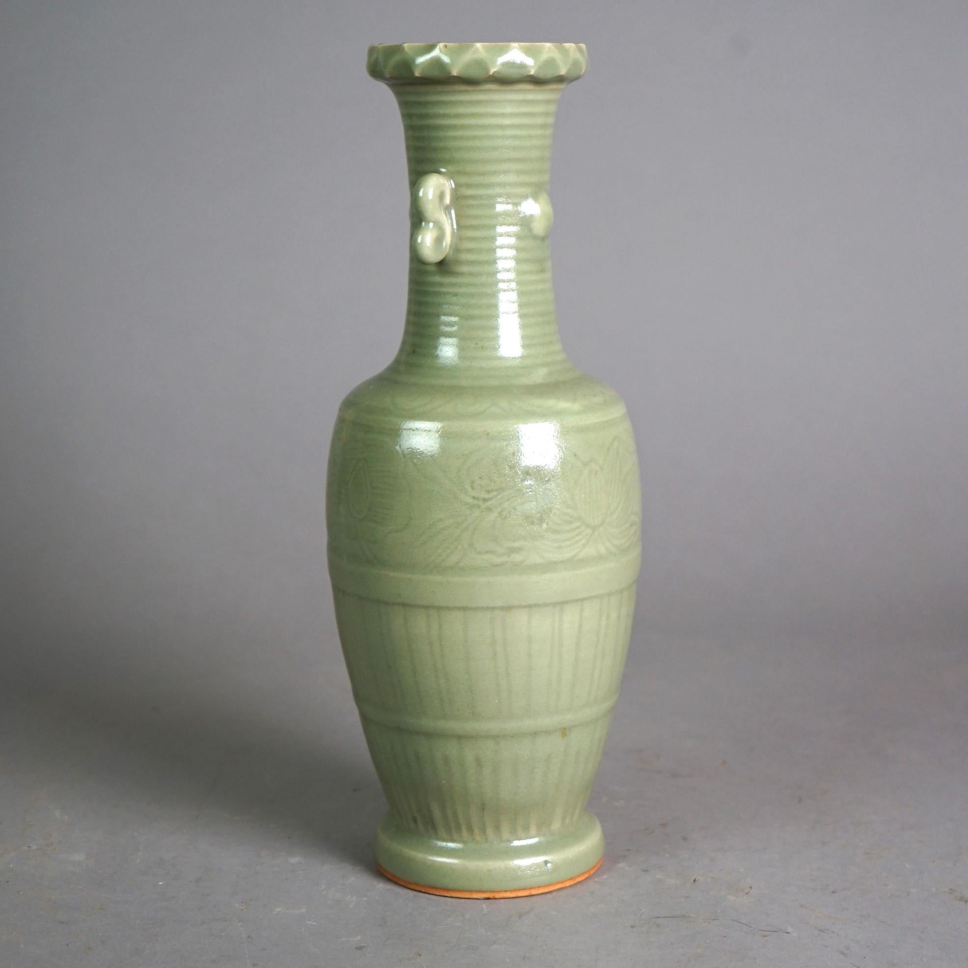 An antique Chinese vase offers art pottery construction with double scroll form handles, incised decoration and celadon glaze, c1930

Measures - 13.5