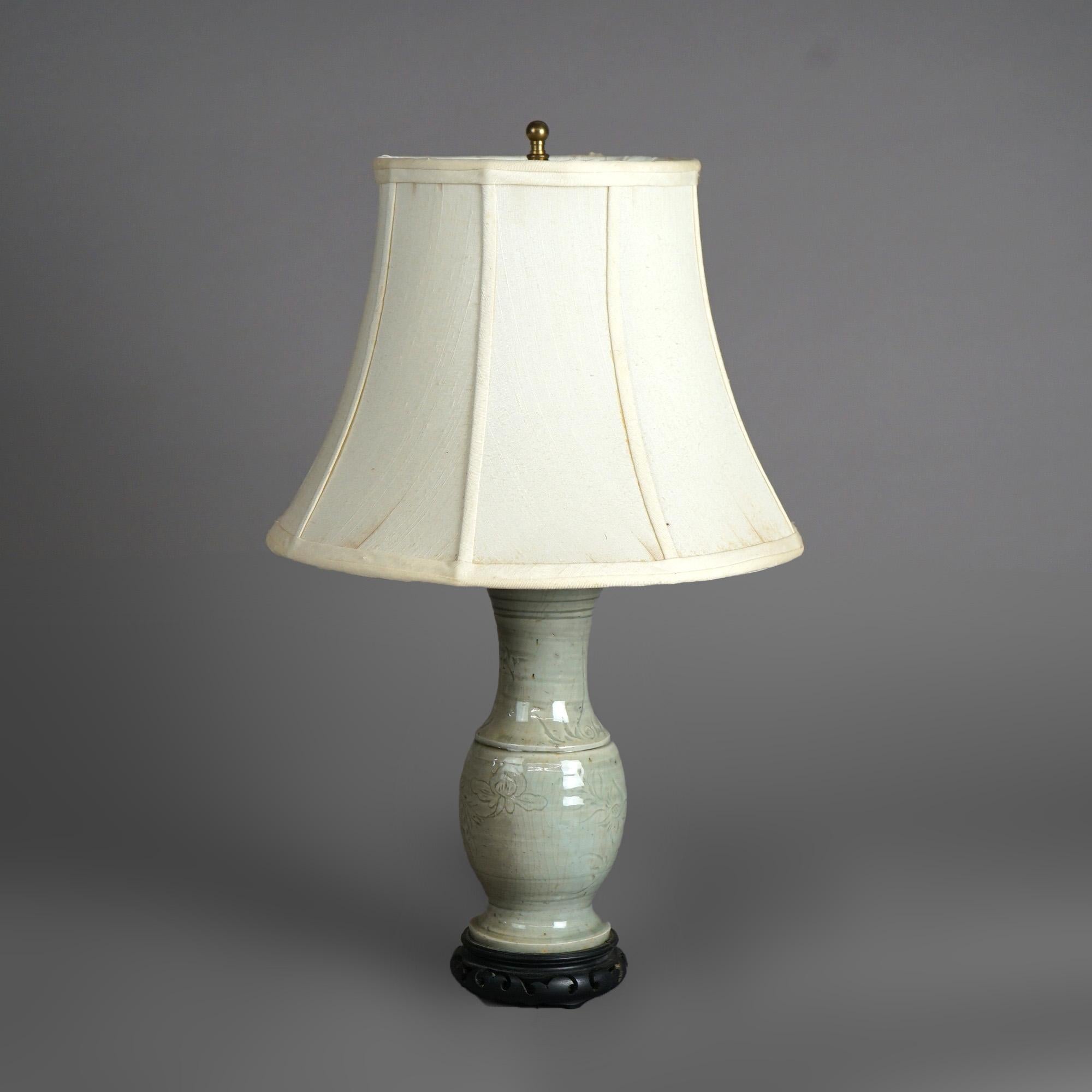 An antique table lamp offers Chinese art pottery vase with incised foliate decoration and crazed celedon glazing, c1930

Measures - 20.25