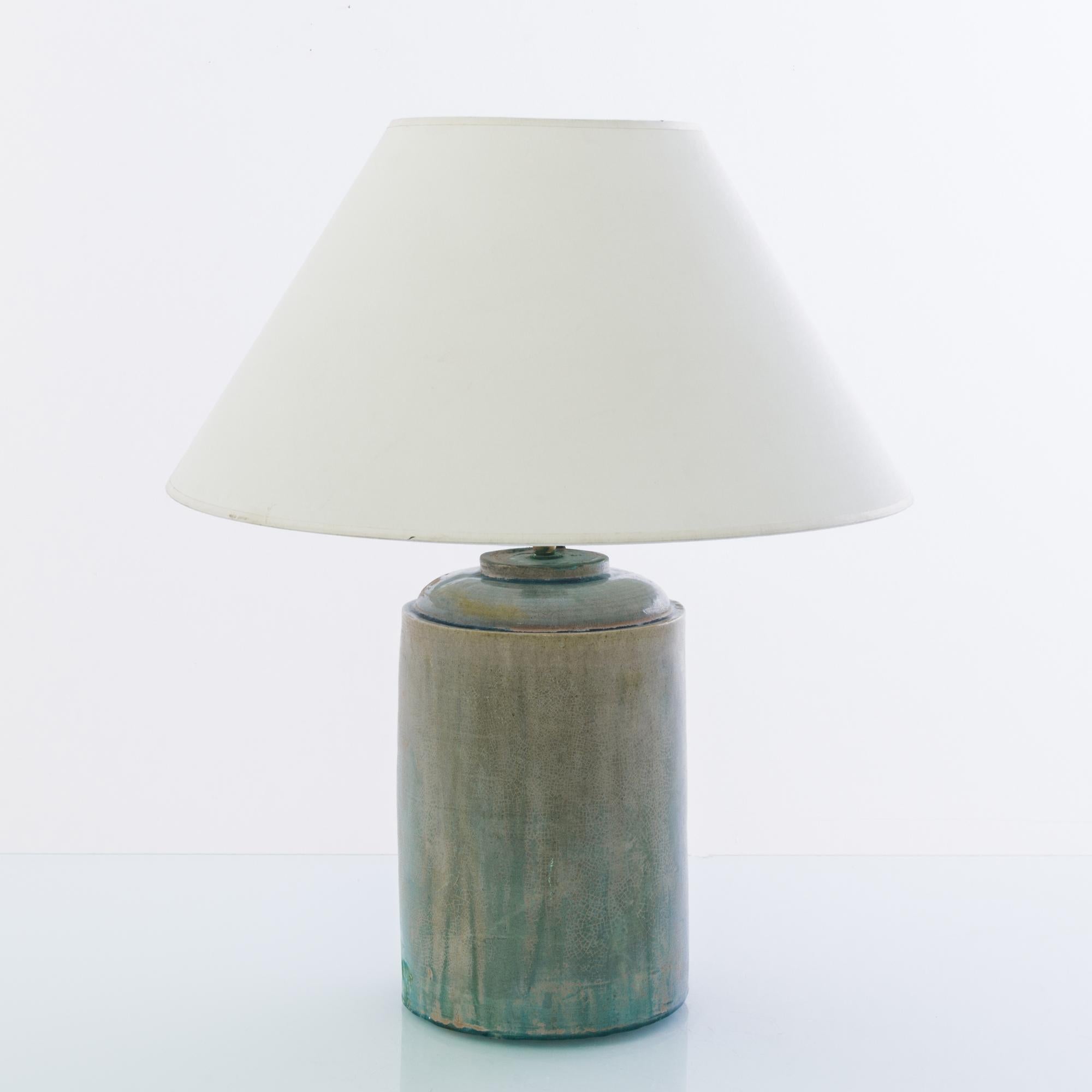 A vintage Chinese vase, fitted with an adjustable brass fixture and E26 lighting socket. The ombre sunset celadon glaze creates a vivid visual impact. Textured glazes, attractive colors and stout shape grants a rustic tactility to the form. Crowned