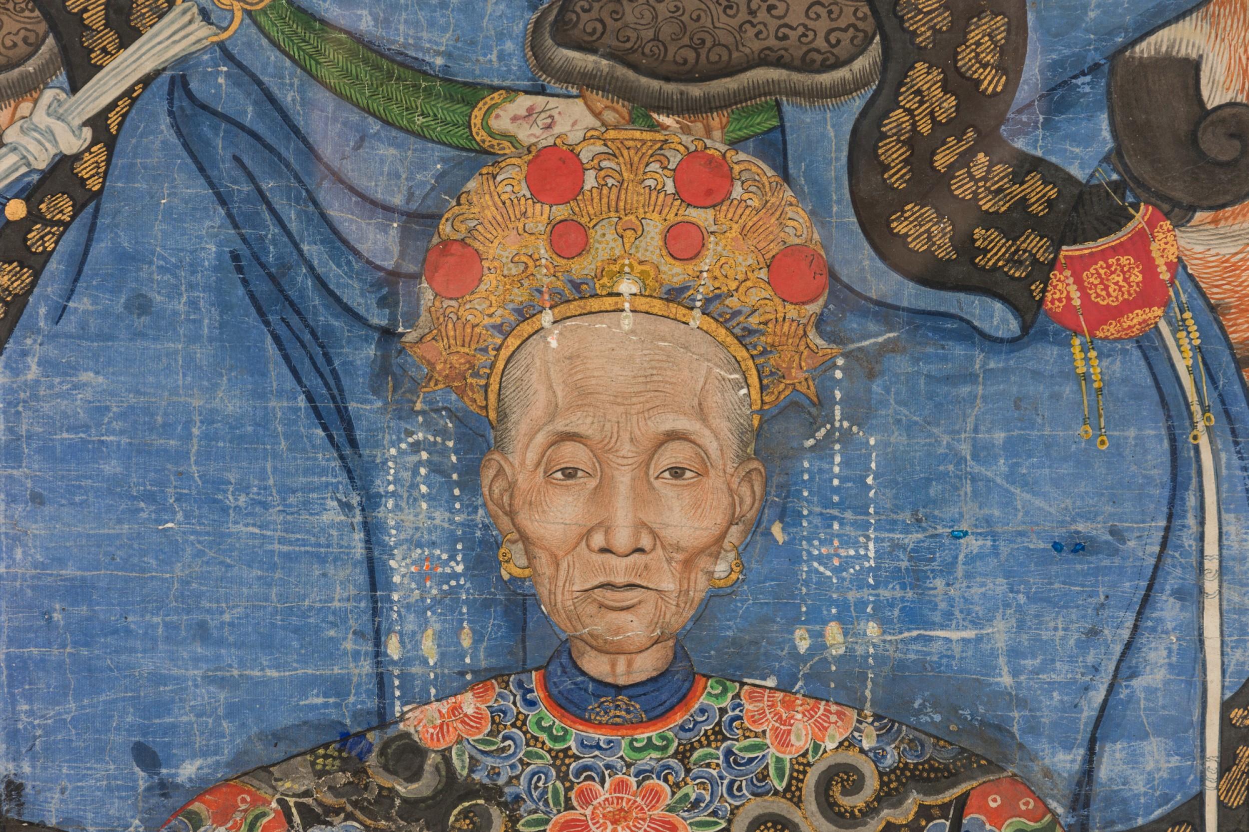 Antique Chinese ceremonial ancestor portrait featuring four elder figures in elaborately decorated blue and red robes on paper mounted in a rectangular wooden frame.