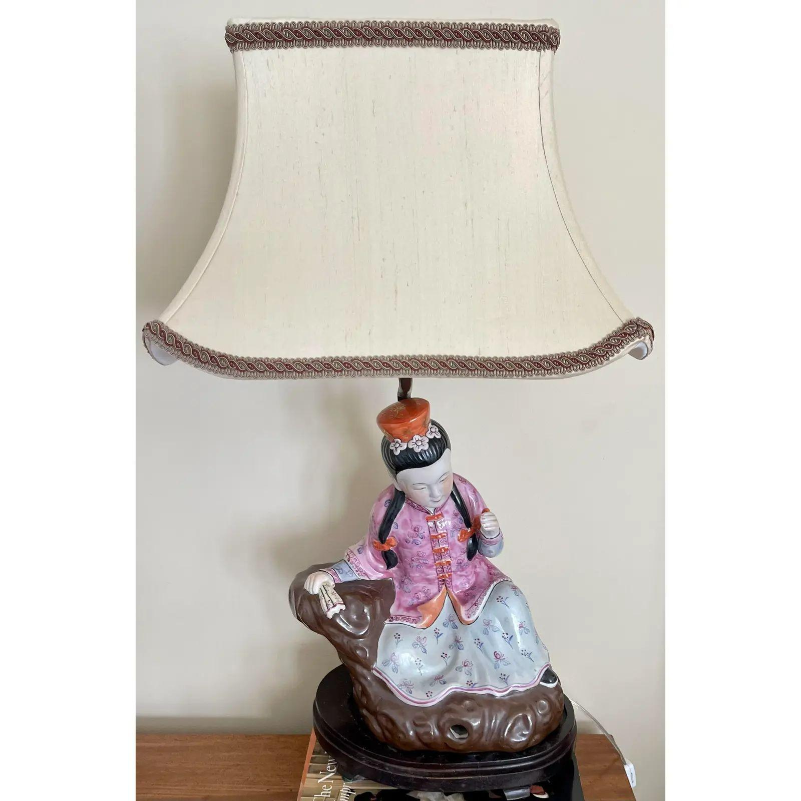 Antique Chinese Ching Dynasty seated famille rose figurines now designer table lamps. These lovely figures set freely on the lamp stands and have not been drilled. They depict a man and a woman seated in lovely famile rose Chinese pottery. They are