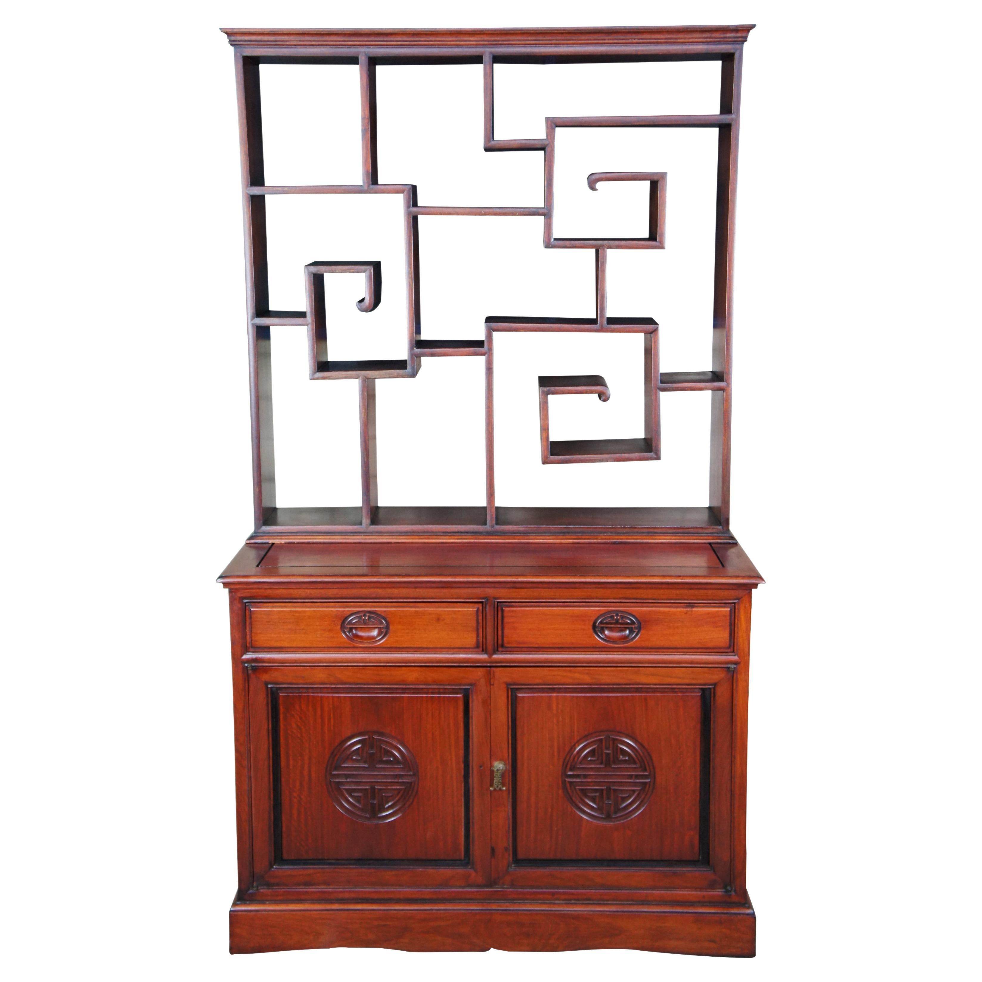 Antique Chinese Chinoiserie Ming Rosewood etagere cabinet. Made of solid rosewood featuring tiered upper bookcase curio shelving with two lower drawers and one cabinet.

Measures: 19