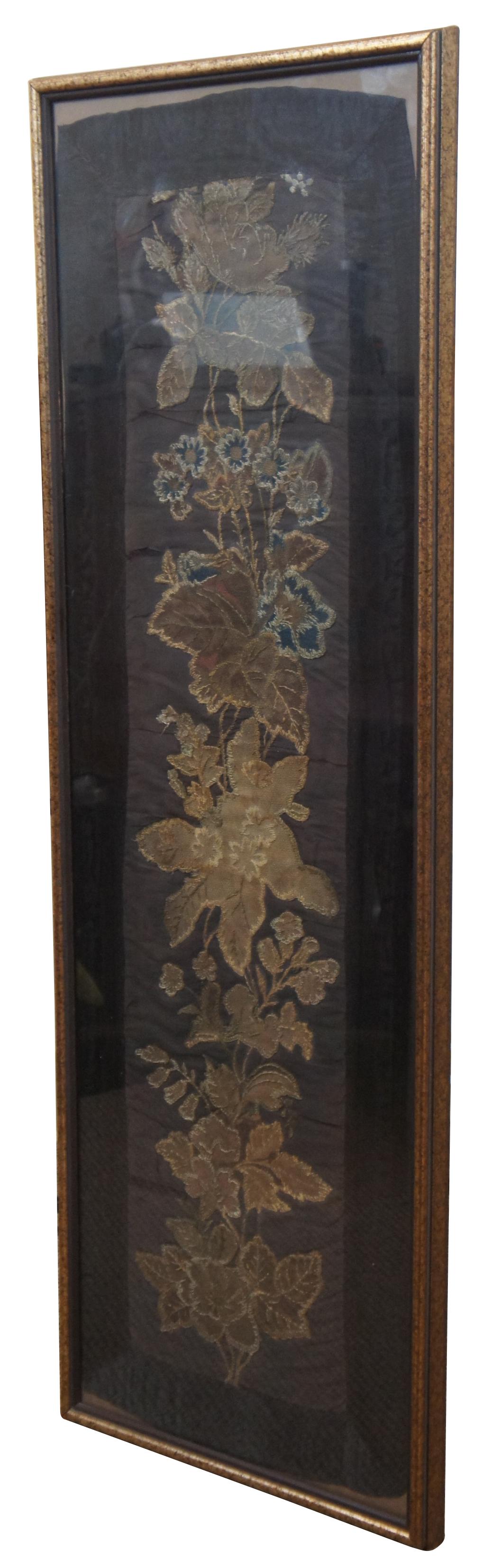 Large antique framed Chinese black silk folk art textile / tapestry panel or table runner embroidered with brown, gold and blue flowers / leaves.

13.5” x 1” x 41.25” / Sans Frame - 12” x 39.5” (Width x Depth x Height).