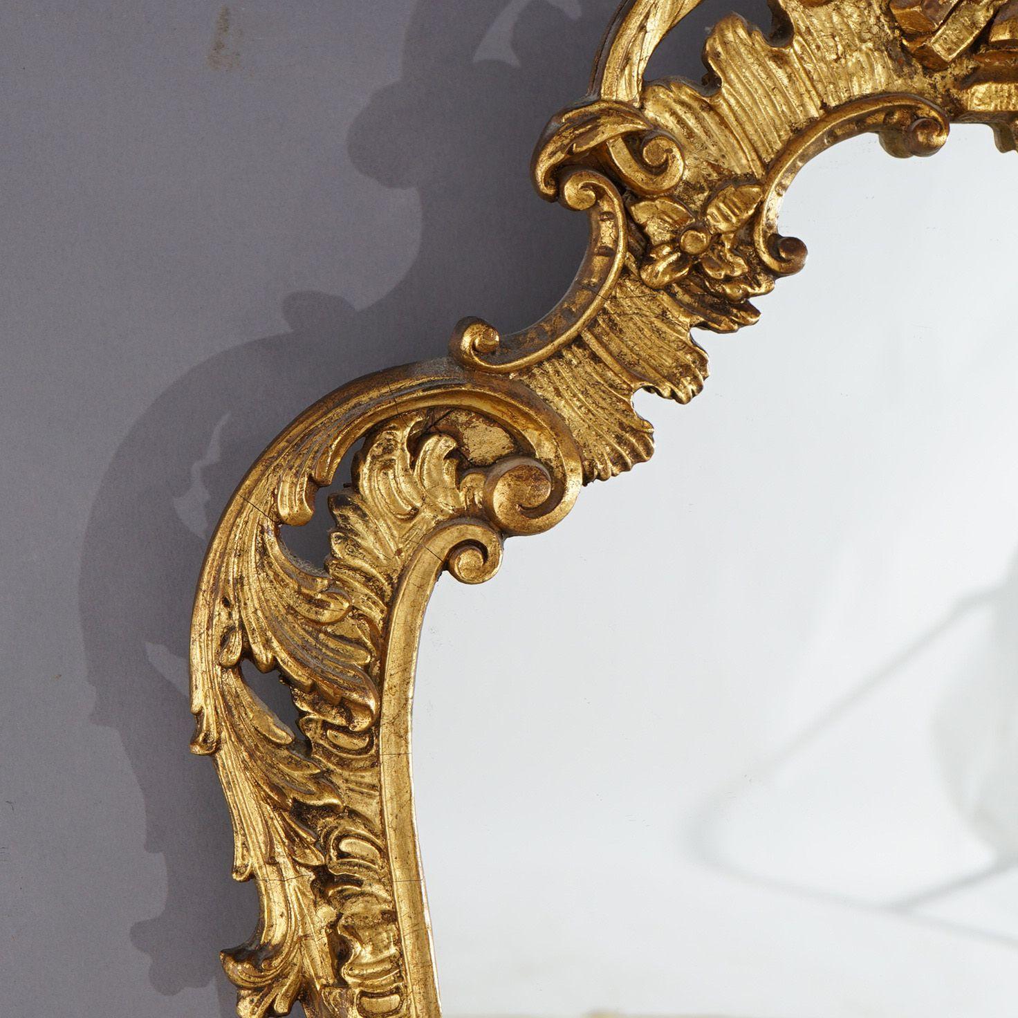 An antique Chinese Chippendale figural wall mirror offers giltwood frame with phoenix crest over shaped mirror having foliate form surround, c1930

Measures - 40.75