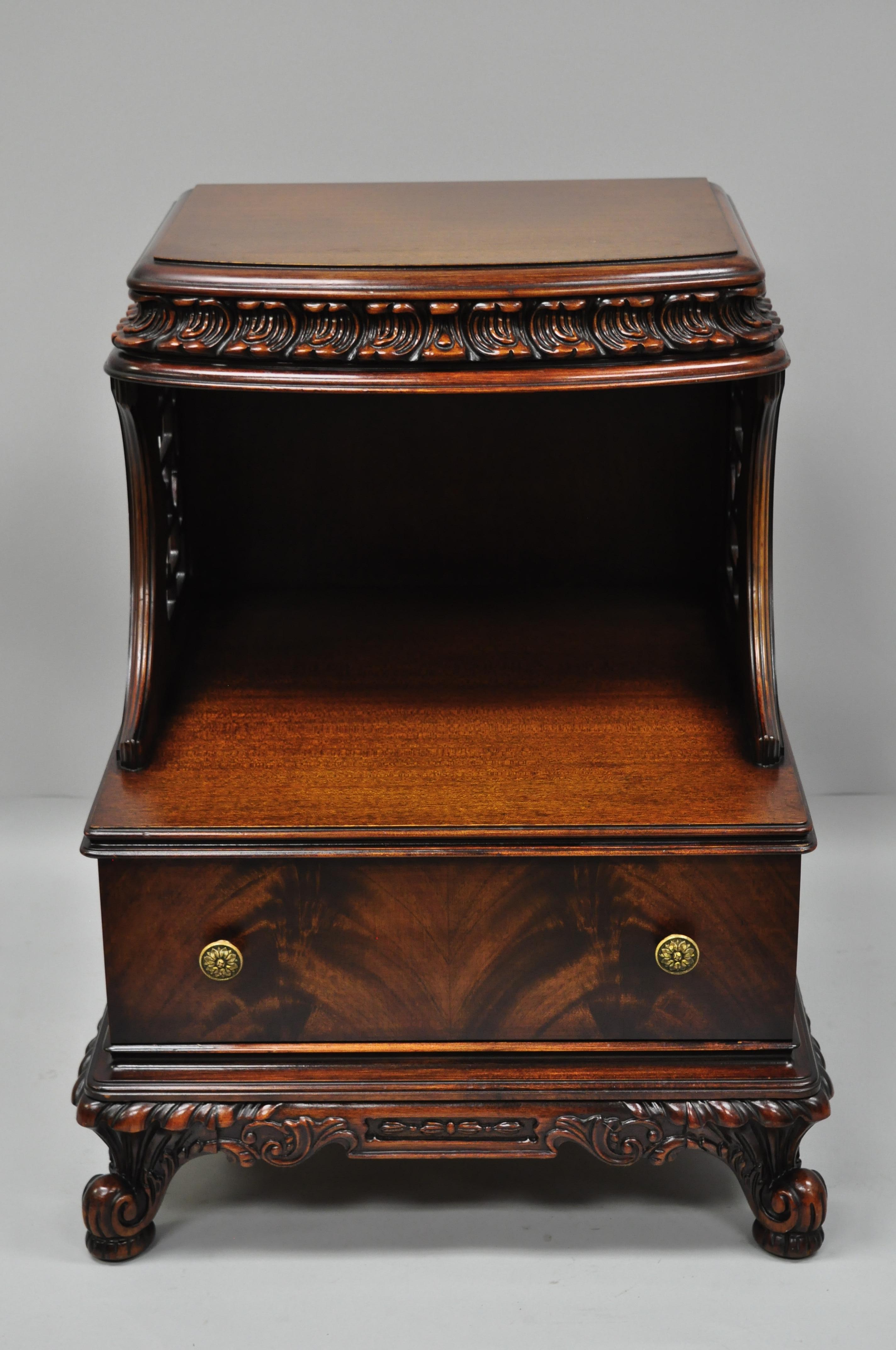 Antique Chinese Chippendale flame mahogany step down nightstand side table. Item features lattice cutout sides, ornately carved border, beautiful wood grain, cabriole legs, and quality American craftsmanship, circa early to mid-20th century.