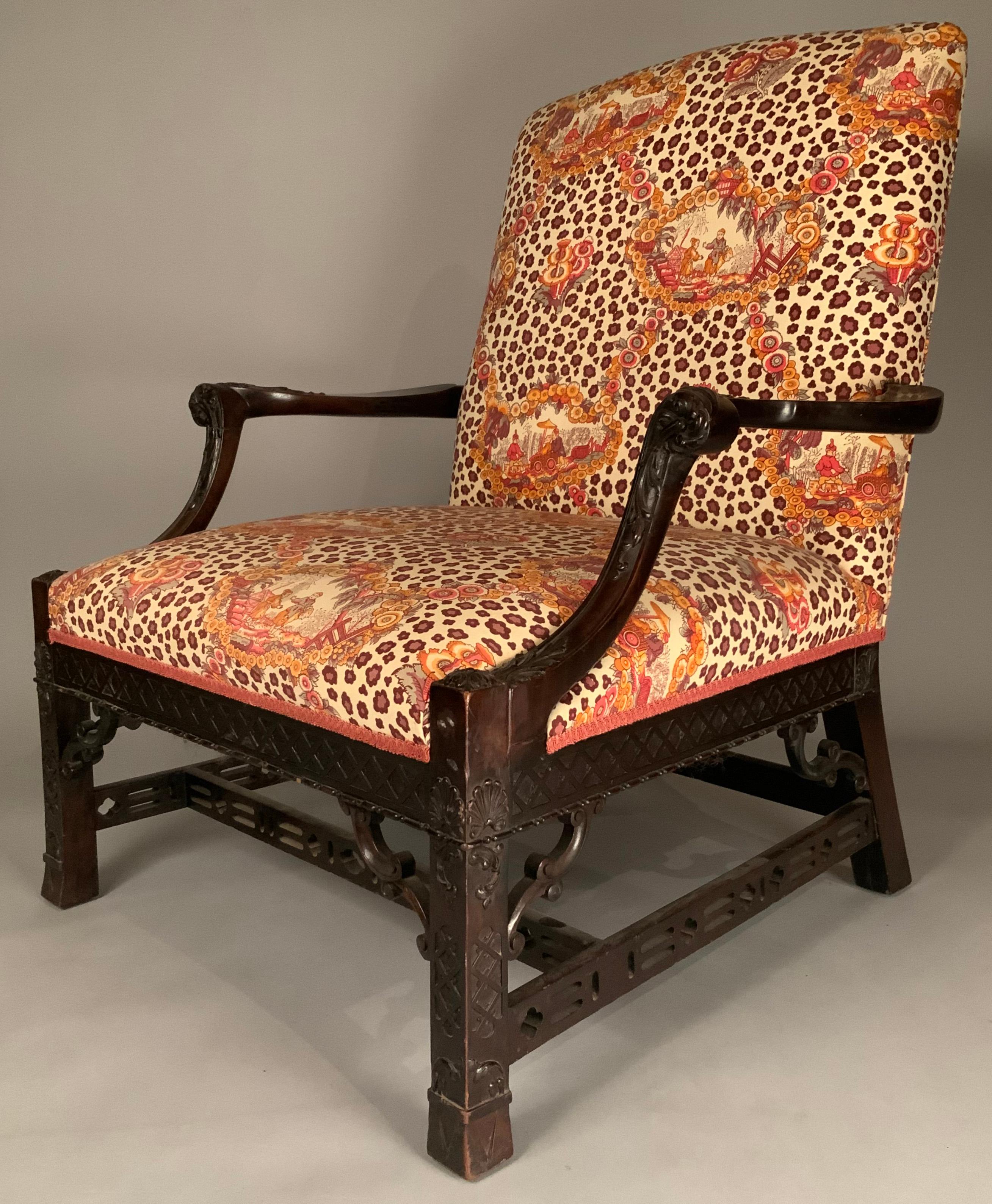 a beautiful and substantial large antique Chinese Chippendale Lounge Chair, c. 1940. Wonderful carved frame with fretwork panels around the base, and wonderful details all around. In its original pictorial upholstery fabric, which is in good