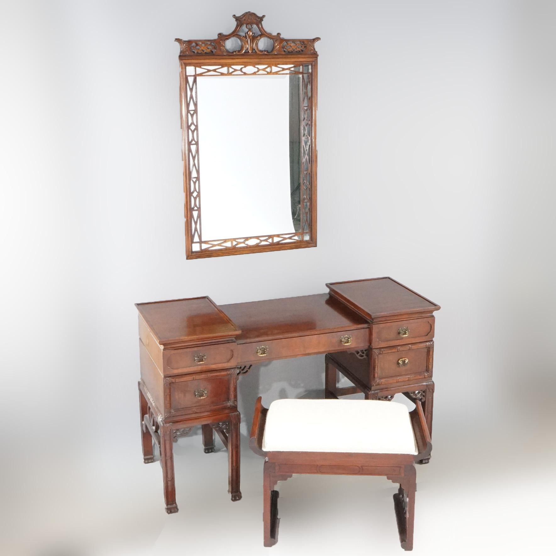 An antique Chinese Chippendale dressing set offers mahogany construction with dressing table, upholstered bench and wall mirror, c1940

Measures: Table 30.25''H x 49.5''W x 20''D;  Mirror 43.75''H x 27''W x 1.25'' D;  Bench 19''H x 26.5''W x