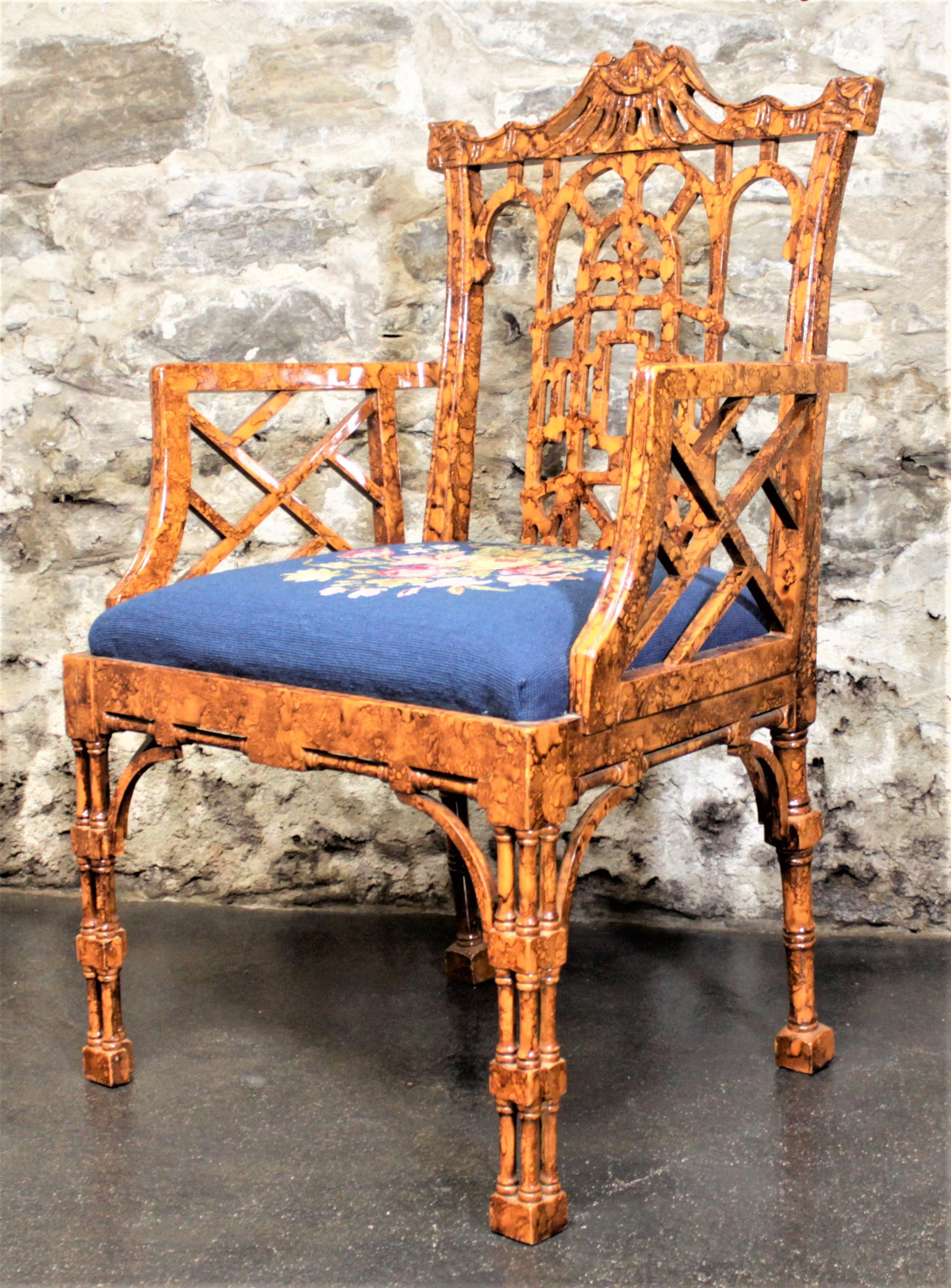 This vintage Chinese Chippendale or Bohemian styled accent chair is presumed to have been manufactured in the United States in circa 1950. The frame is done in a sculptured wood to mimic bamboo stalks and covered with a bright honey amber lacquer