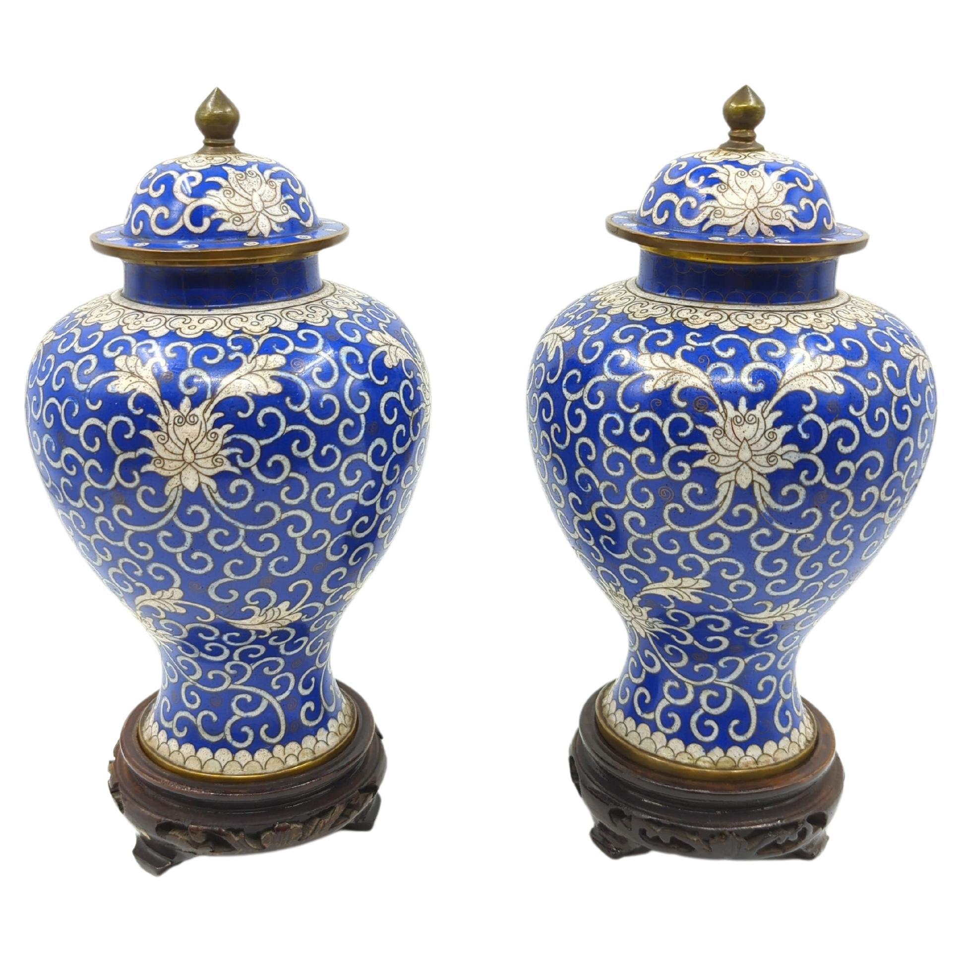 This exquisite matching pair of antique Chinese export blue and white cloisonné covered general jars is a fine example of the intricate artistry and craftsmanship of traditional Chinese decorative arts. Crafted in the elegant baluster form, these