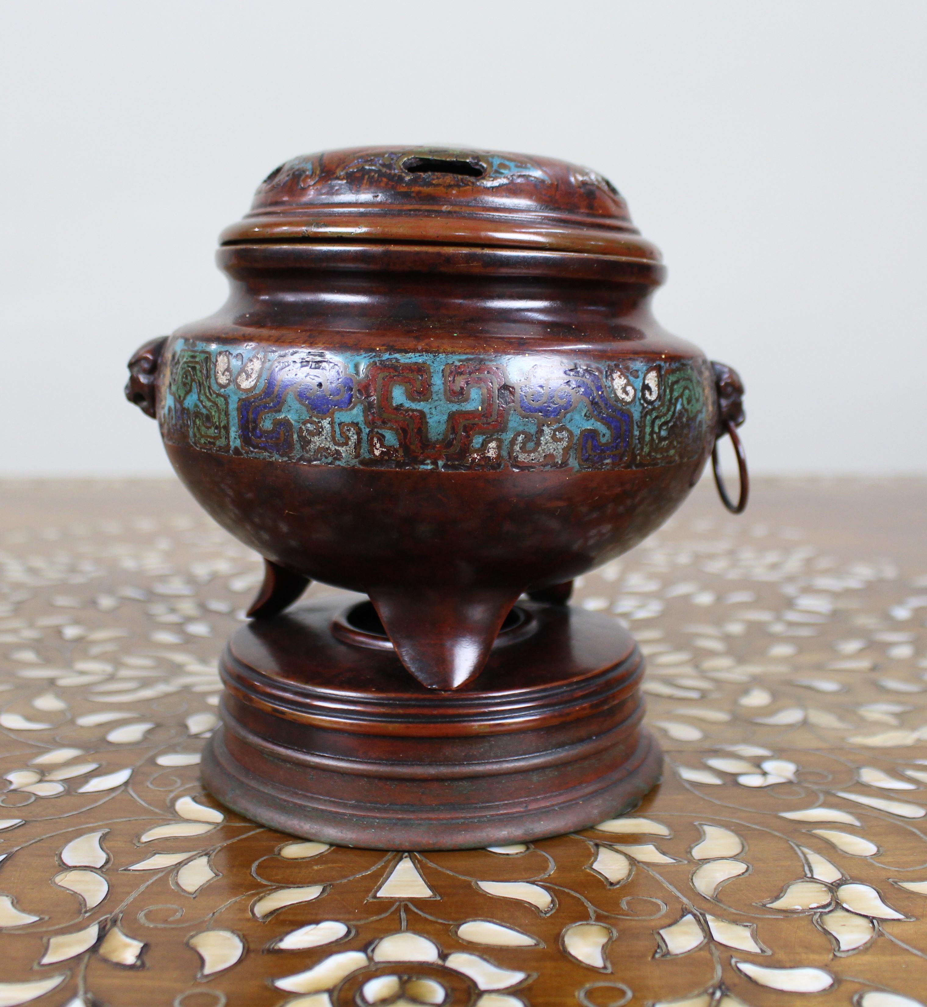 Antique Chinese Cloisonné Bronze Tripod Censer, c.1890

A fine Chinese cloisonné bronze censer from the late Qing Dynasty, circa 1890. Of tripod form, the rounded body is decorated with a continuous band of cloisonné enamel in archaistic scroll