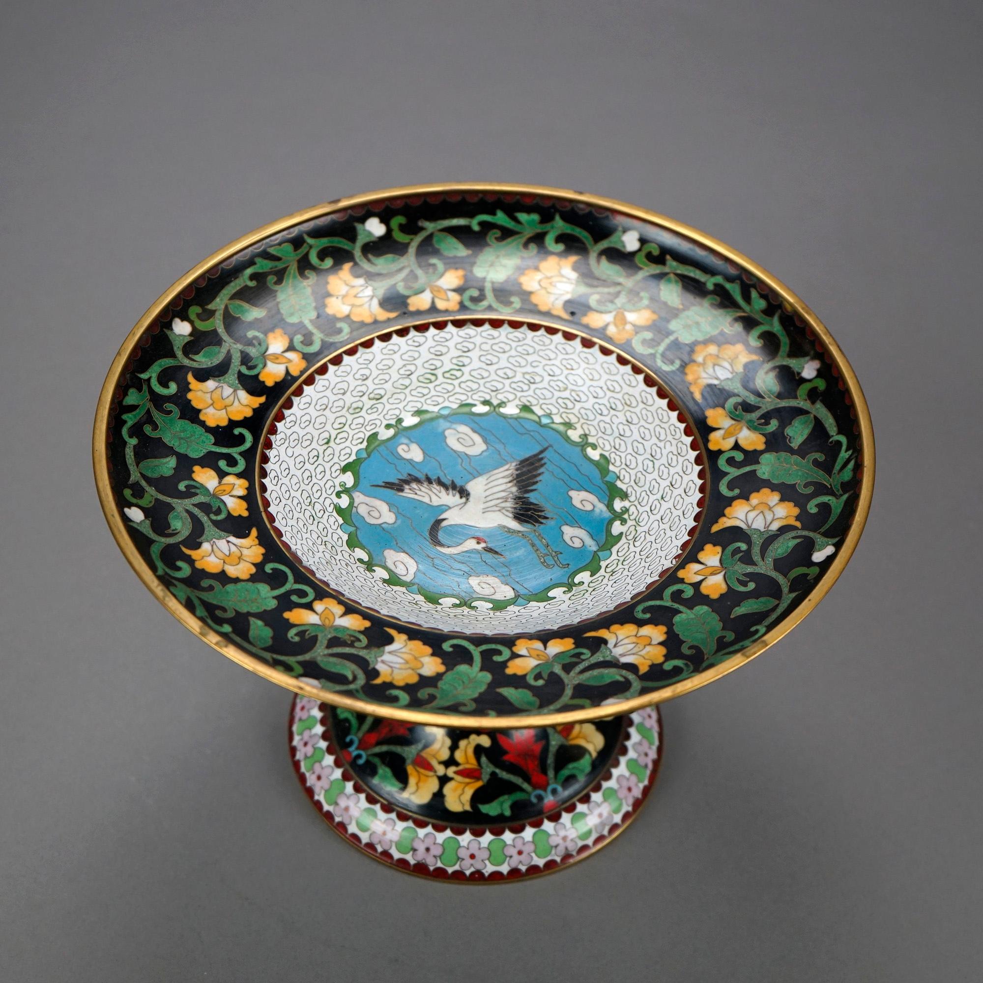 A Chinese Cloisonne compote offers enamel decorated construction with bowl having central swan (or heron) in marsh setting with floral bordering, raised on flared pedestal, c1930

Measures- 6.5''H x 10.25''W x 10.25''D

Catalogue Note: Ask about