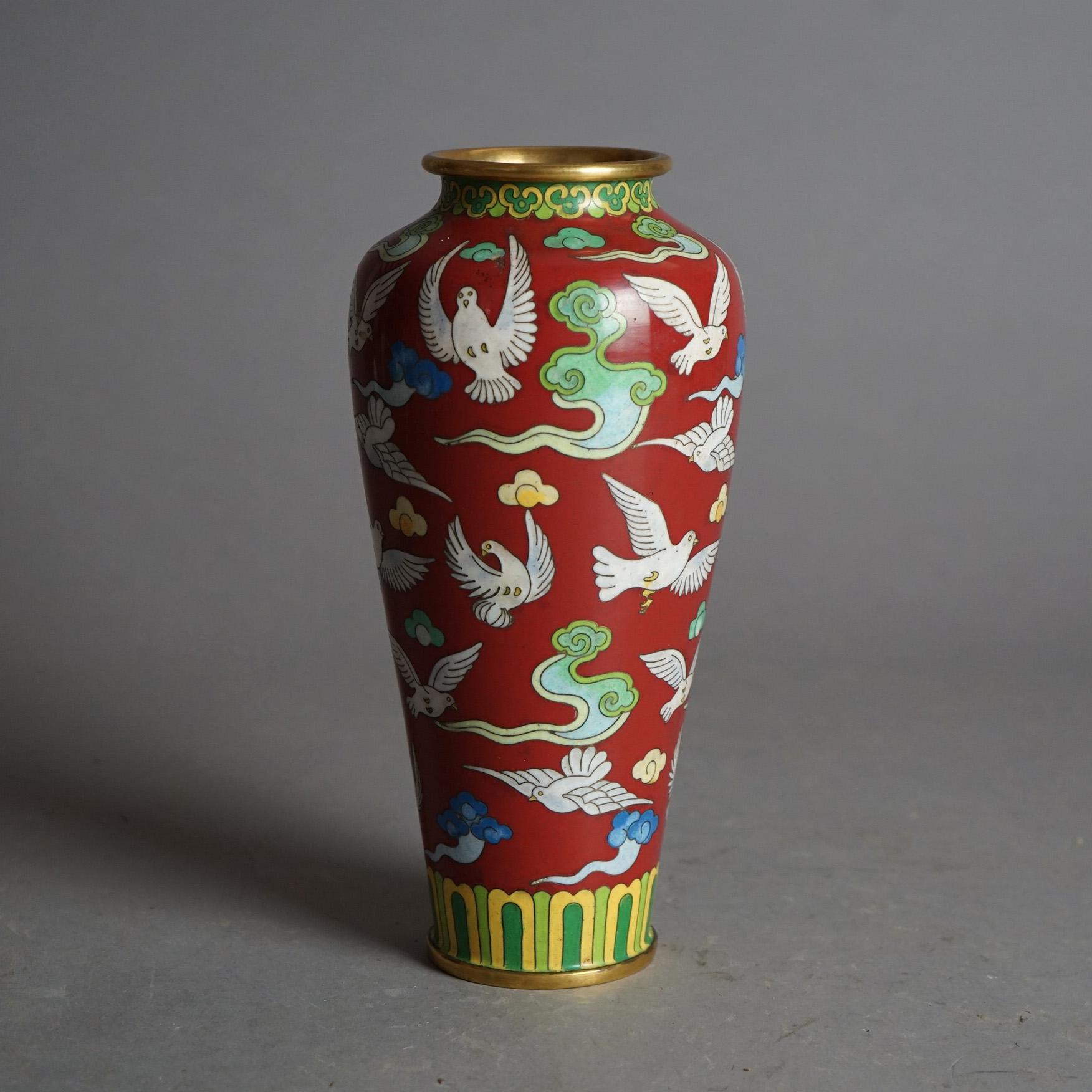 An antique Chinese vase offers metal construction with Cloisonne enameled allover dove (bird) and cloud design, c1920

Measures - 9