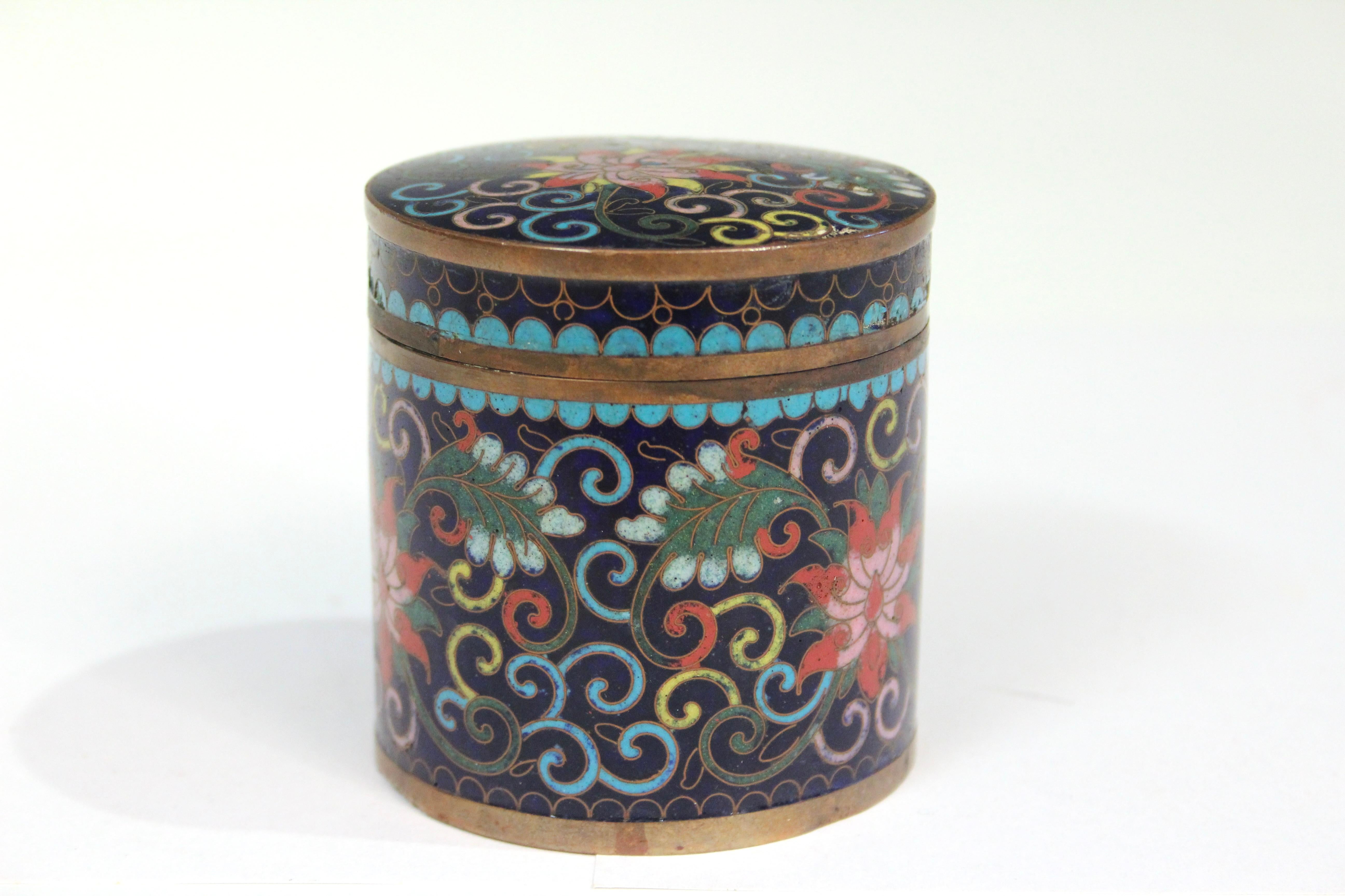 Antique Chinese cloisonne cannister with cover. Decorated with lotus flowers and scrolls in nice detail with great color and blending qualities. Tight fitting cover. Circa mid 19th century. 3 1/4