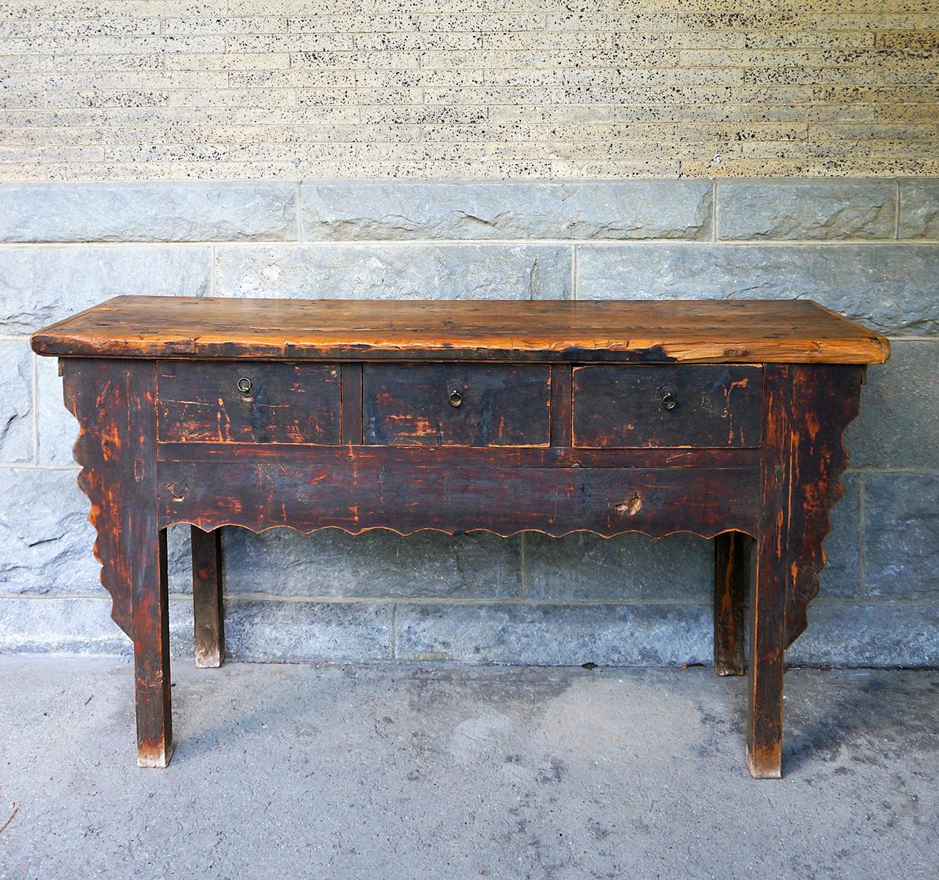 Rustic country style Chinese altar table or sideboard, circa 1780, with three drawers. The straight-forward lines are elevated with the carved decorative brackets and apron. The top is made of three boards with breadboard ends. and the entire piece