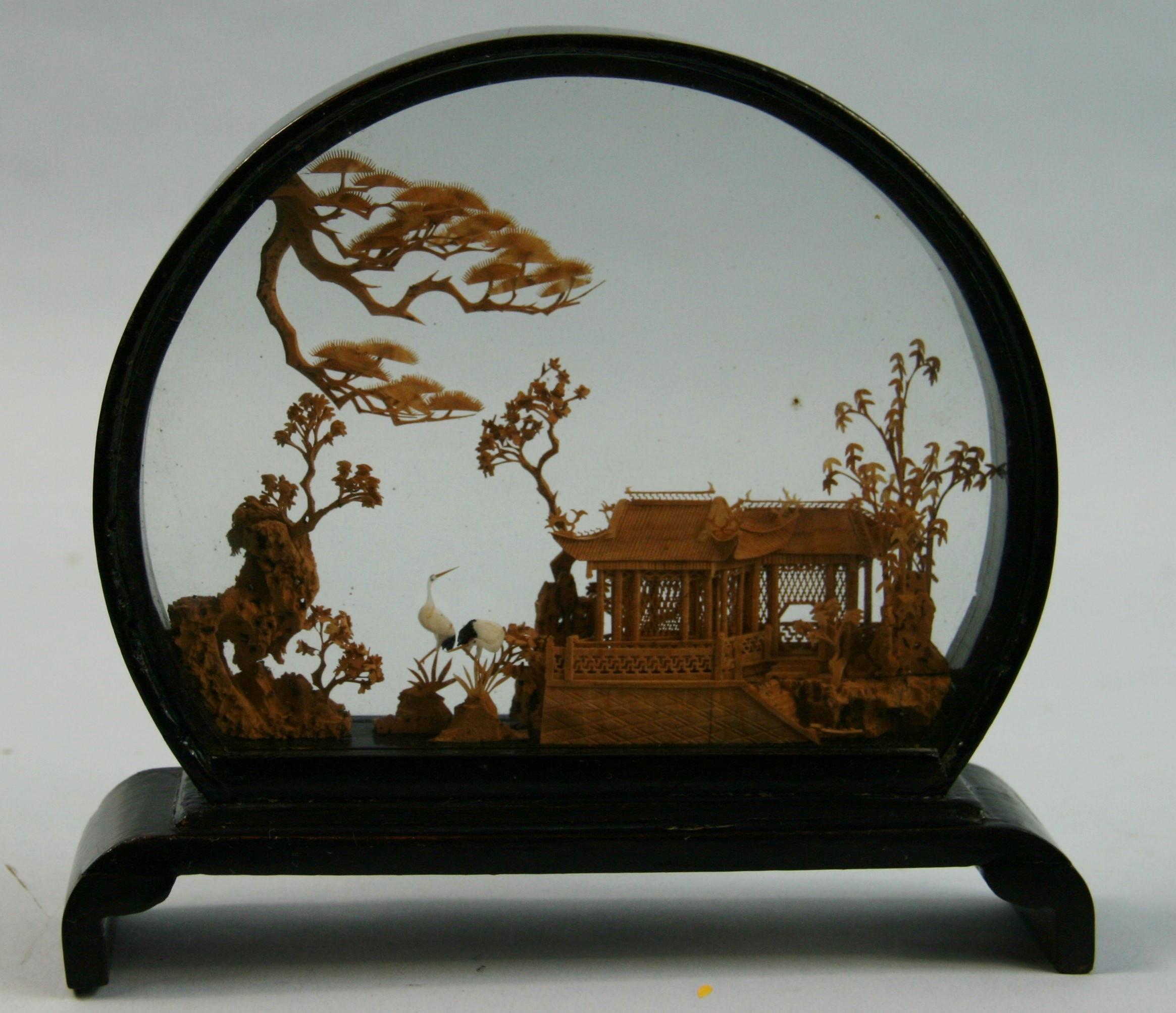 3-716 Chinese diorama made of vintage glass and lacquered wood.
Careful delicate work of miniature sculpture representing a Chinese landscape view, a pagoda in a traditional garden surrounded by conifers, bamboo racks and craines.
