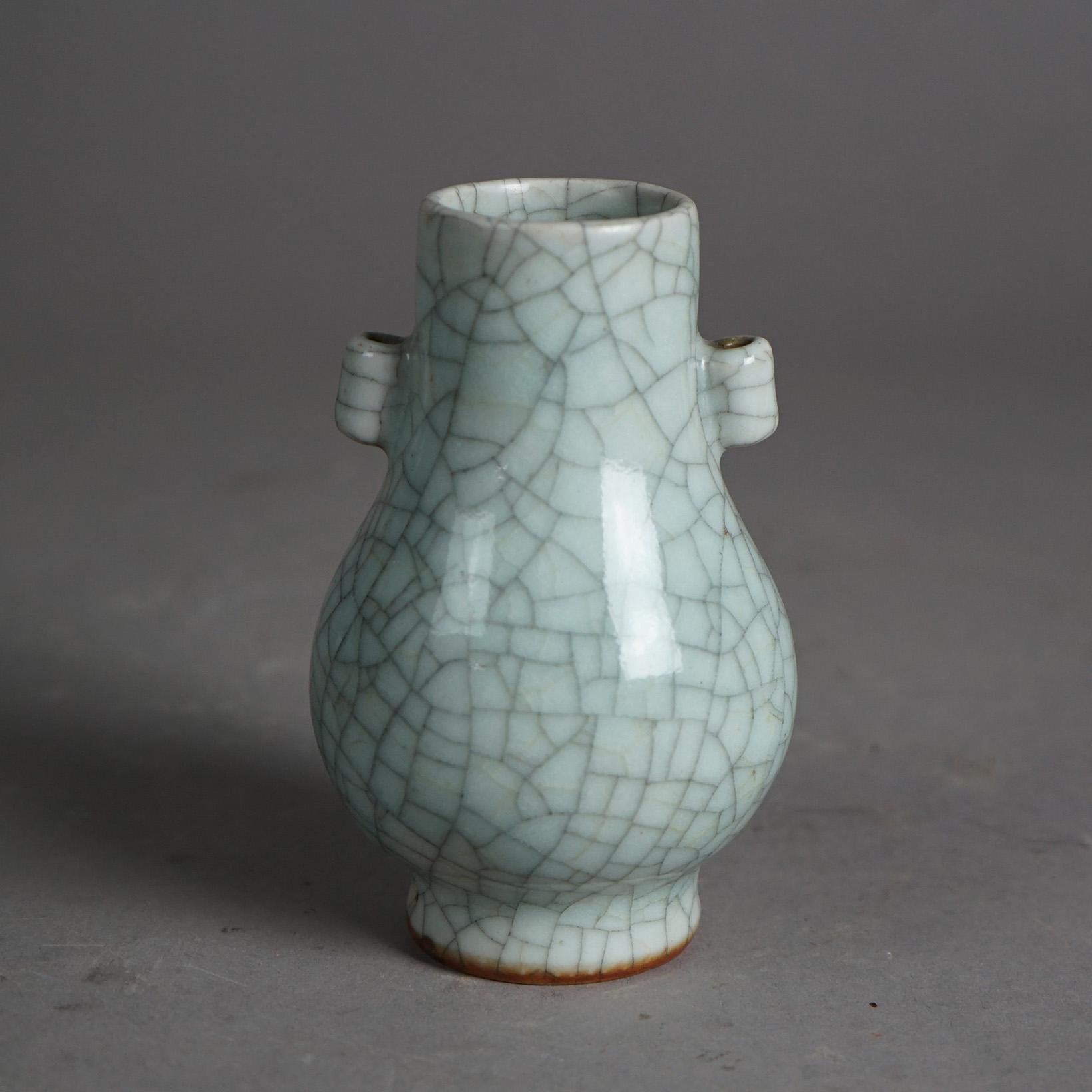 An antique Chinese vase offers art pottery construction with double handles and crackle glaze, c1930

Measures - 5