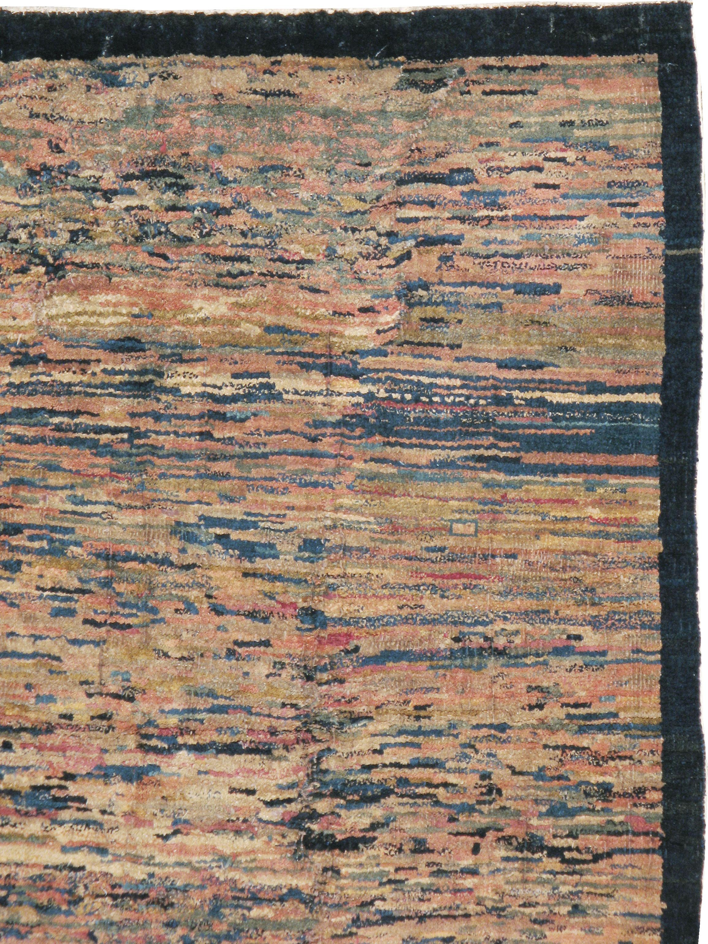 An antique Chinese Art Deco rug from the early 20th century. An ‘end of the day’ rug knotted from all sorts of yarn bits from the workshop left over from larger, patterned pieces. The unique, idiosyncratic nature of these interwar rugs makes them