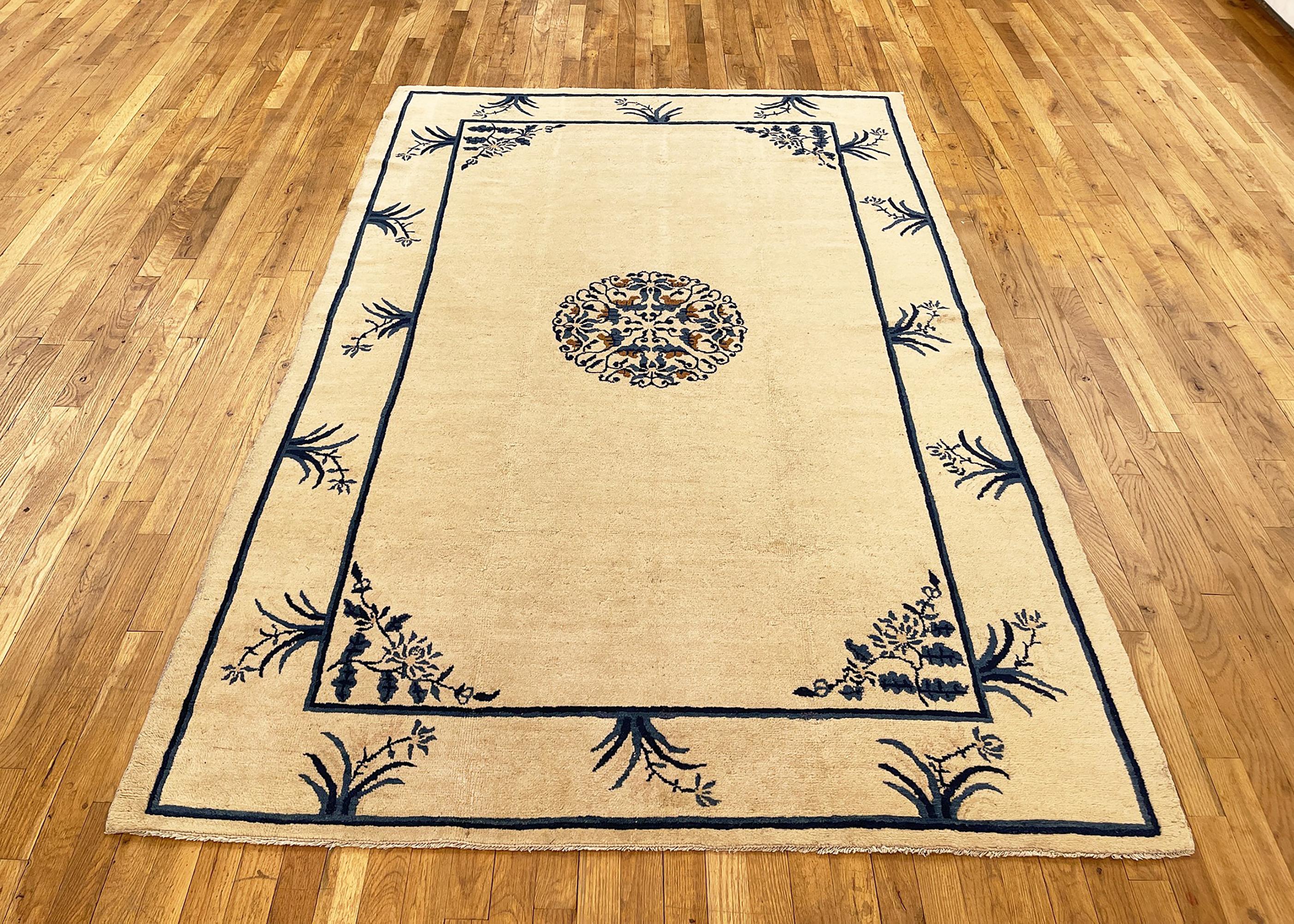 Antique Chinese peking rug, small size, circa 1900.

A one-of-a-kind antique Chinese Mandarin oriental carpet, hand-knotted with medium thickness wool pile. This beautiful rug features a central medallion on an ivory central field, with a blue