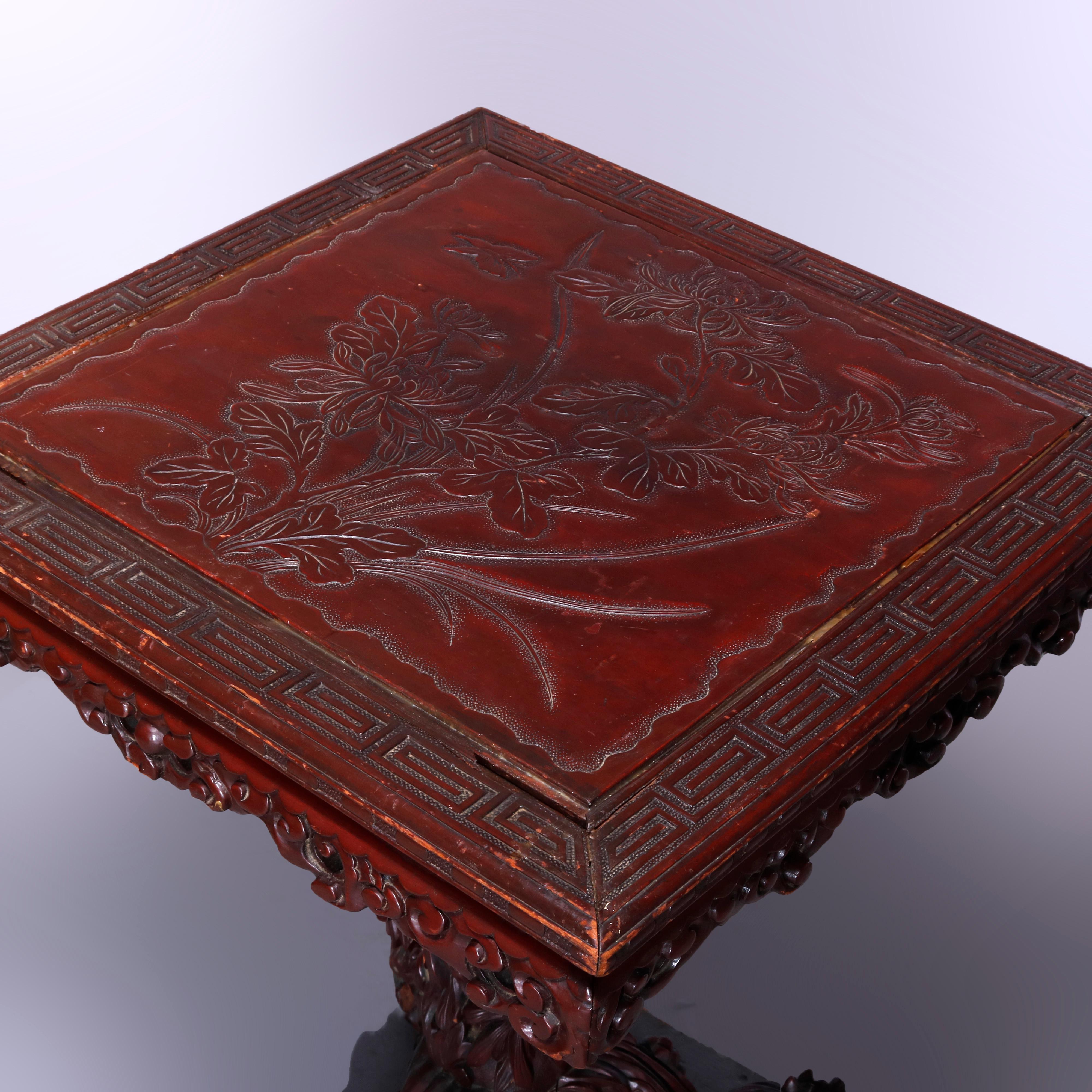 An antique Chinese tilt top table offers carved hardwood construction with top having carved garden scene with Greek Key bordering and foliate carved skirt, raised on deeply carved column with three legs, 19th century

Measures: 30.25