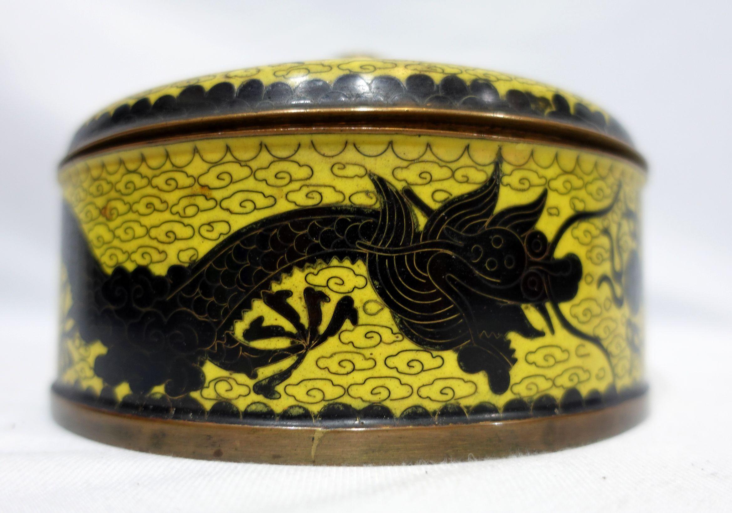 Antique Chinese cloisonné enamel round box with lid depicting flying dragons chasing fireballs. Yellow base and dark dragon color are applied, and 3 compartments are inside. From the 19th century.
4.5