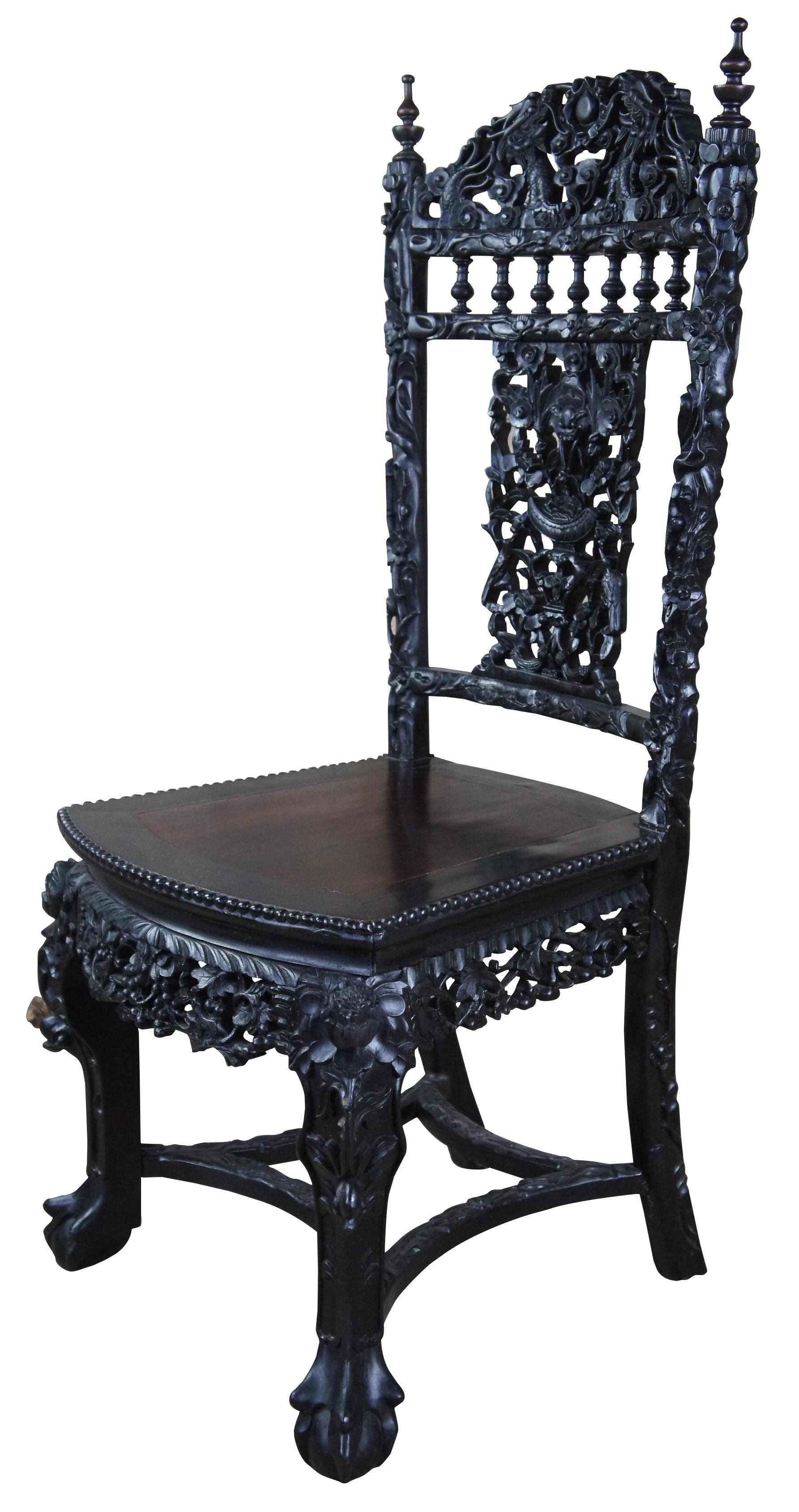 Antique Chinese side dining, scholars, or vanity chair. Made of ebonized Rosewood featuring highly ornate gothic inspired carvings with dragons, bats, squirrels, flowers, nuts, berrys, with beaded edge, finials, and ball and claw feet. This hardwood