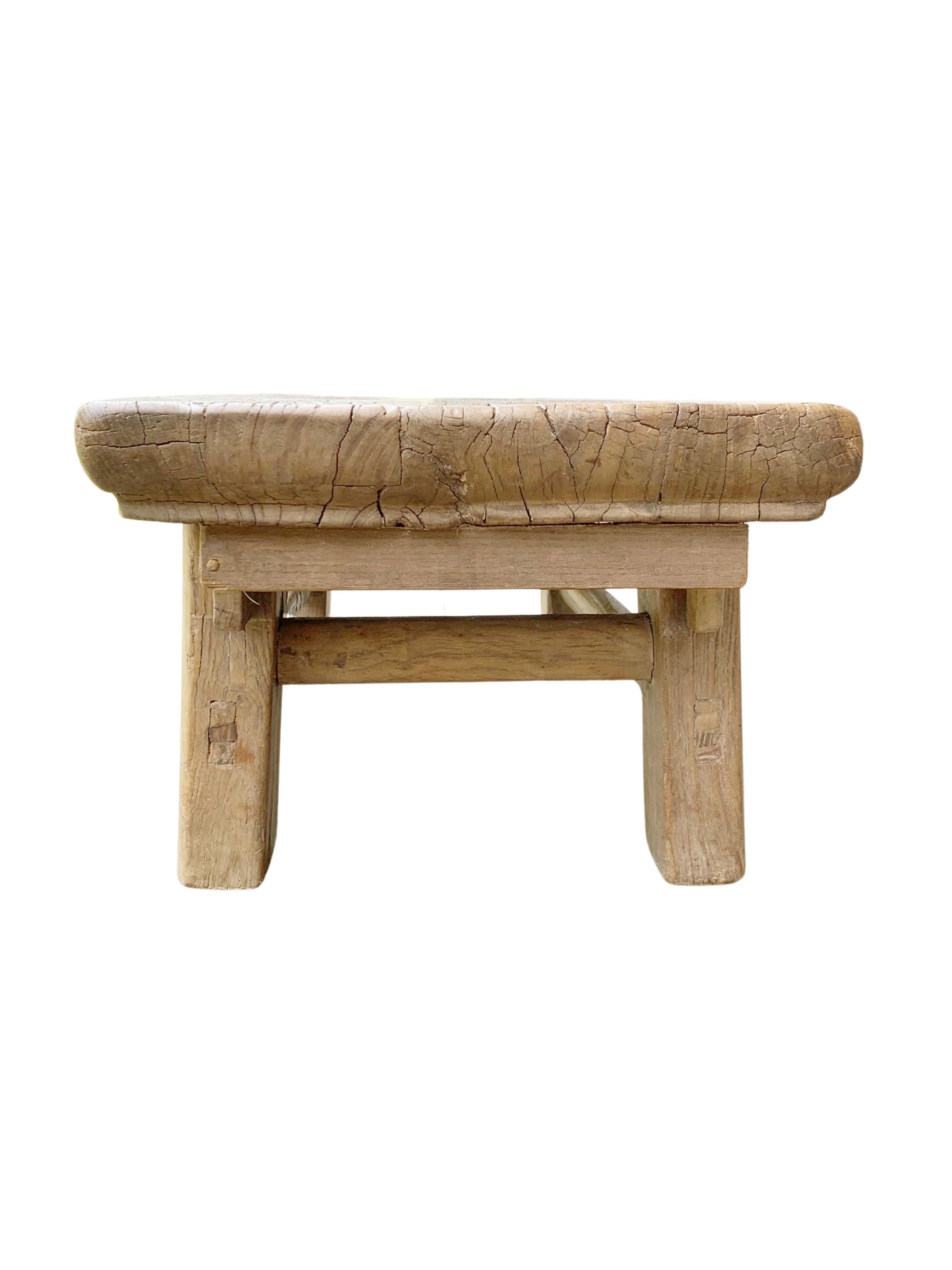 This antique elm wood low stool comes from China's Hubei province. It was crafted using only wooden joints. The elm wood has aged beautifully over its more than 100 years of life. 

Dimensions: height 23 cm x width 68 cm x depth 30 cm.
 