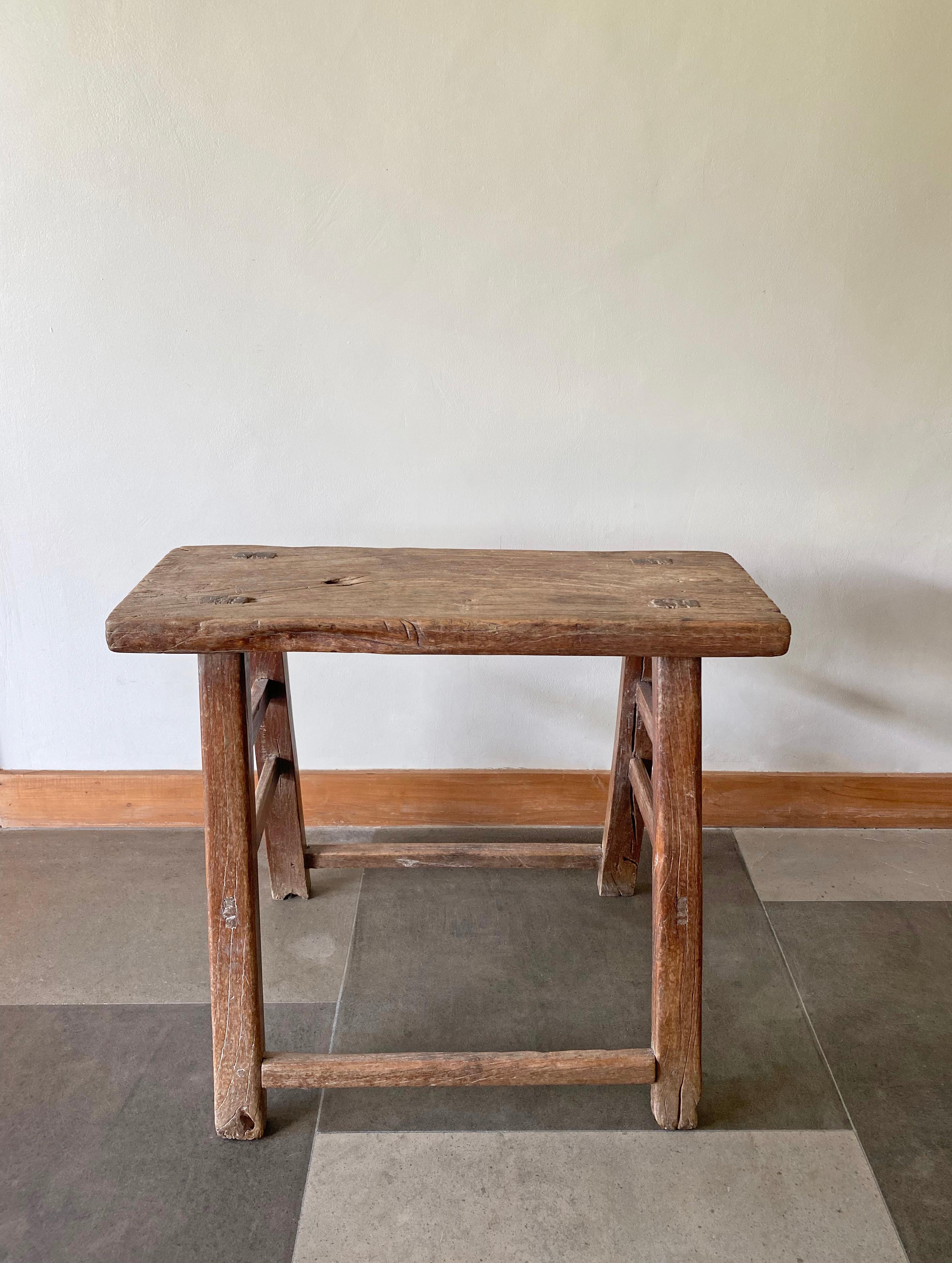This antique elm wood stool comes from China's Hubei province. It was crafted using only wooden joints. The elm wood has aged beautifully over its more than 100 years of life. 

Dimensions: Height 58cm x width 67.5cm x depth 26cm.
  