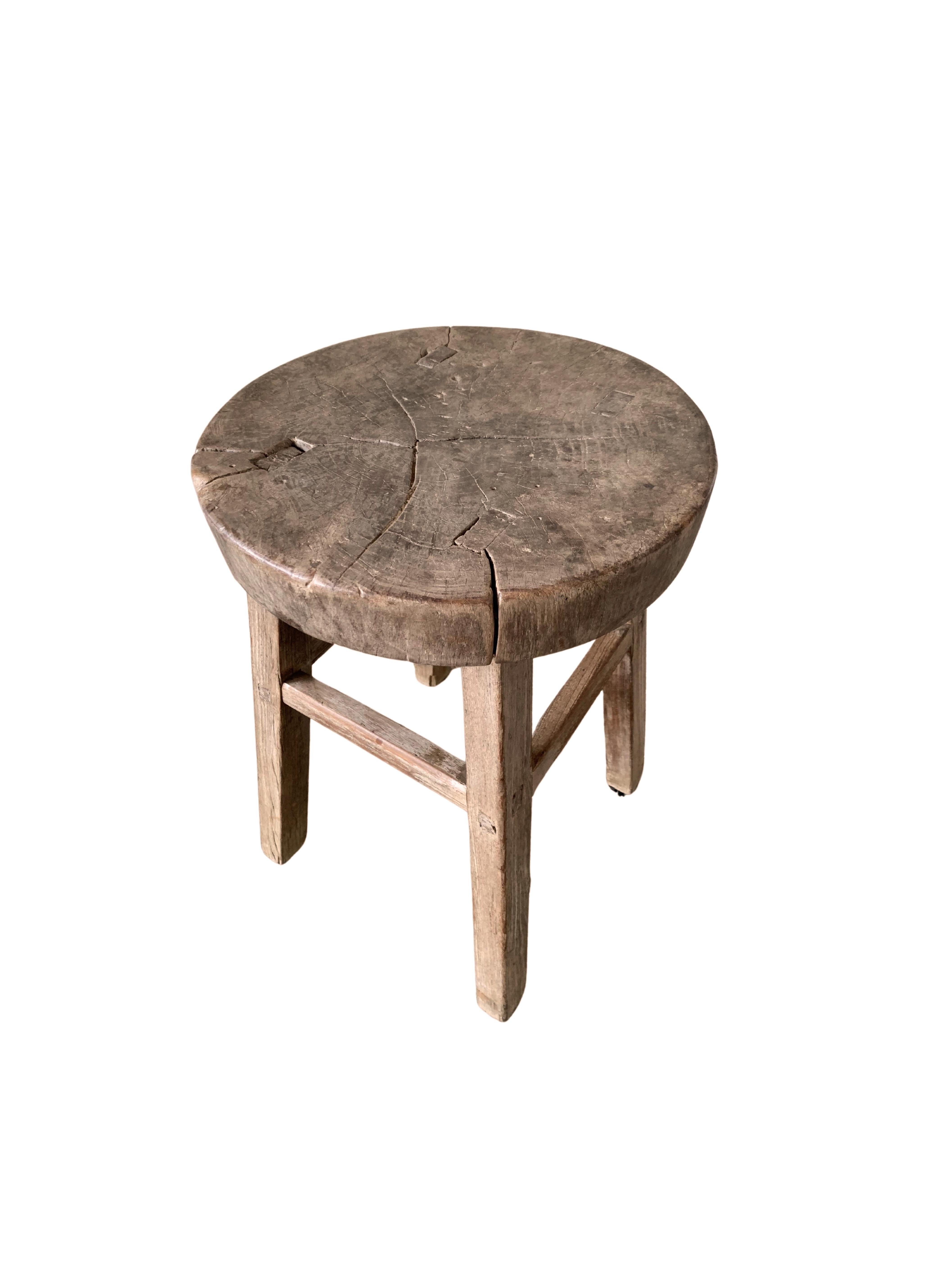 This antique elm wood stool comes from China's Hubei province. It was crafted using only wooden joints. The elm wood has aged beautifully over its more than 100 years of life. The seat is crafted from a thick and textured slab of elmwood. 


