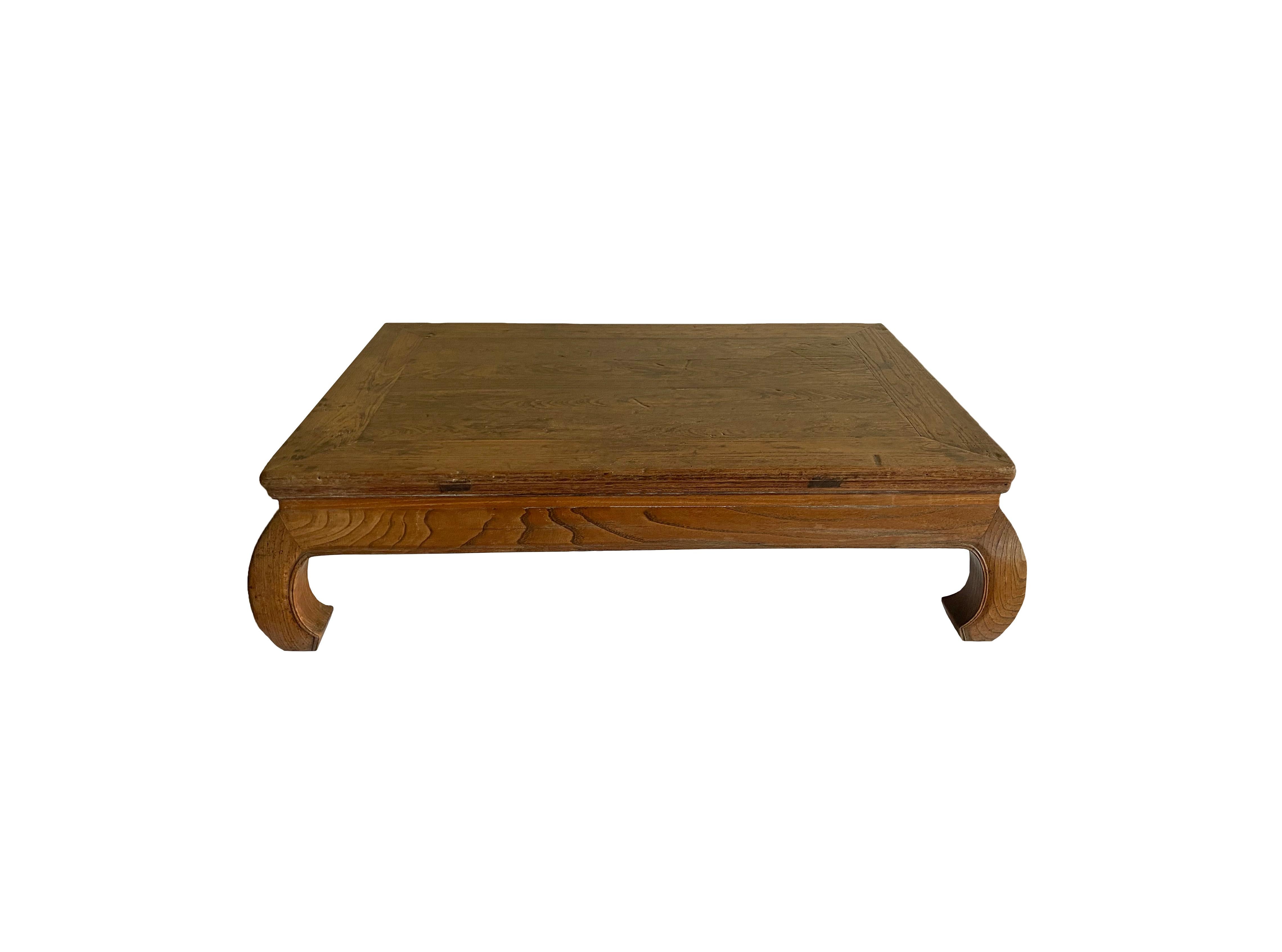 This elmwood opium table from southern China features a lovely wood texture and lacquer finish. A key feature of this table are its bent legs with subtle detailing. 
 