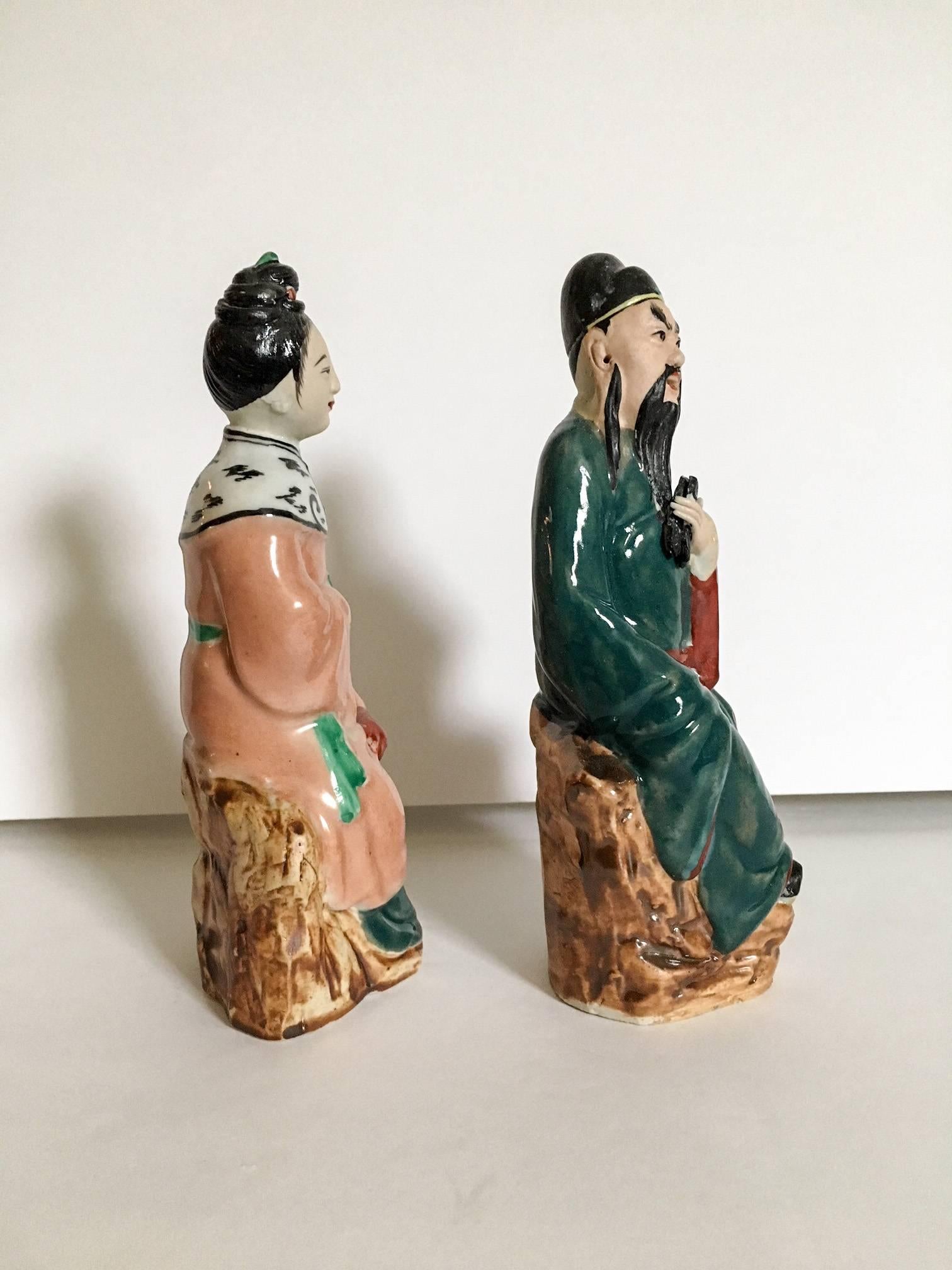 Exquisite pair of antique Chinese mud figure statues of a seated emperor and empress. Embossed on the bottom; maker unknown. Beautifully hand-painted with detailed facial features.