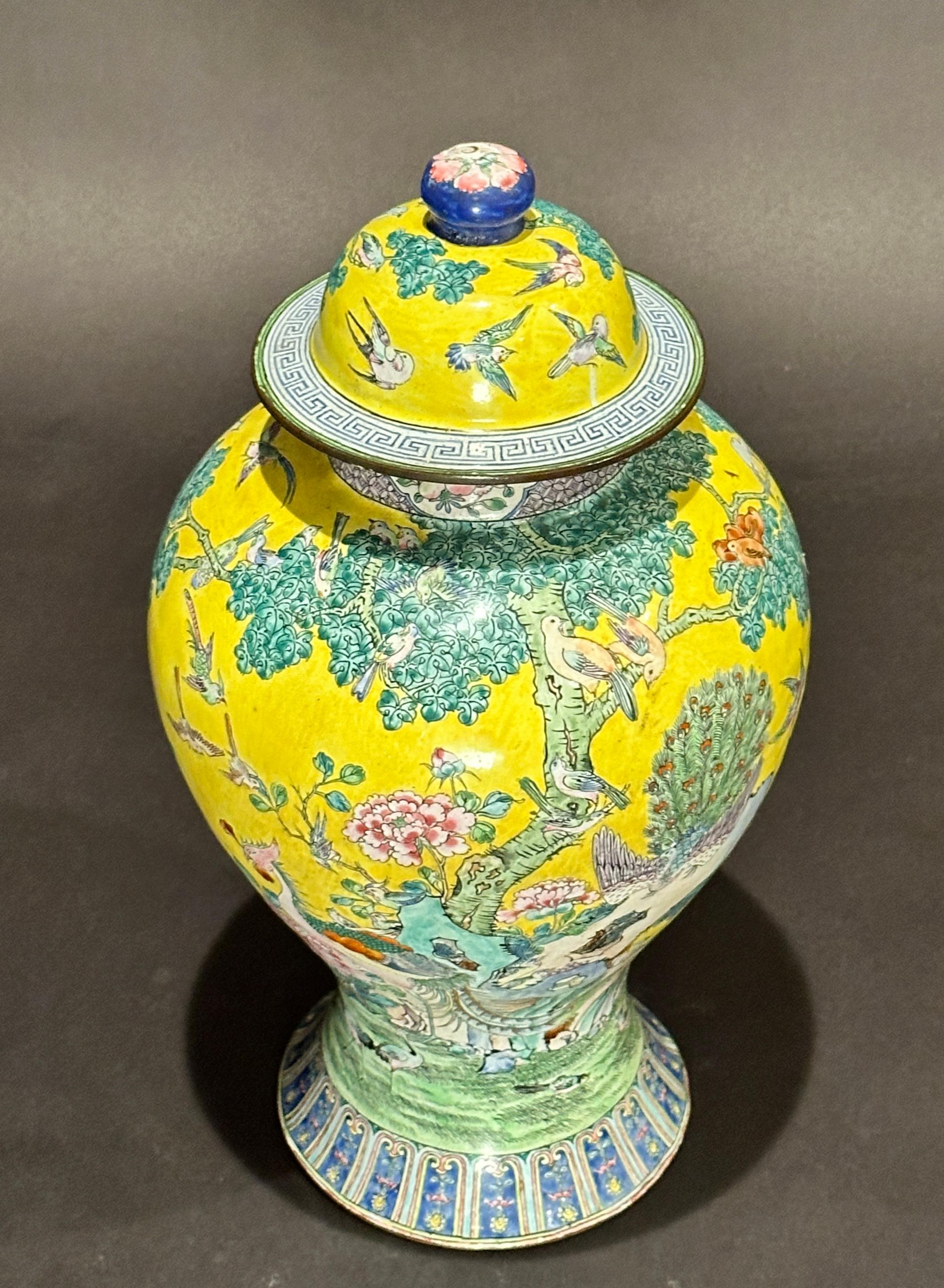 Finely enameled on copper Chinese covered ginger jar vase with yellow ground decoration, scenes of exotic birds and foliage. Colorful jar with yellow, greens. blues and whites. Bottom with double dragon.