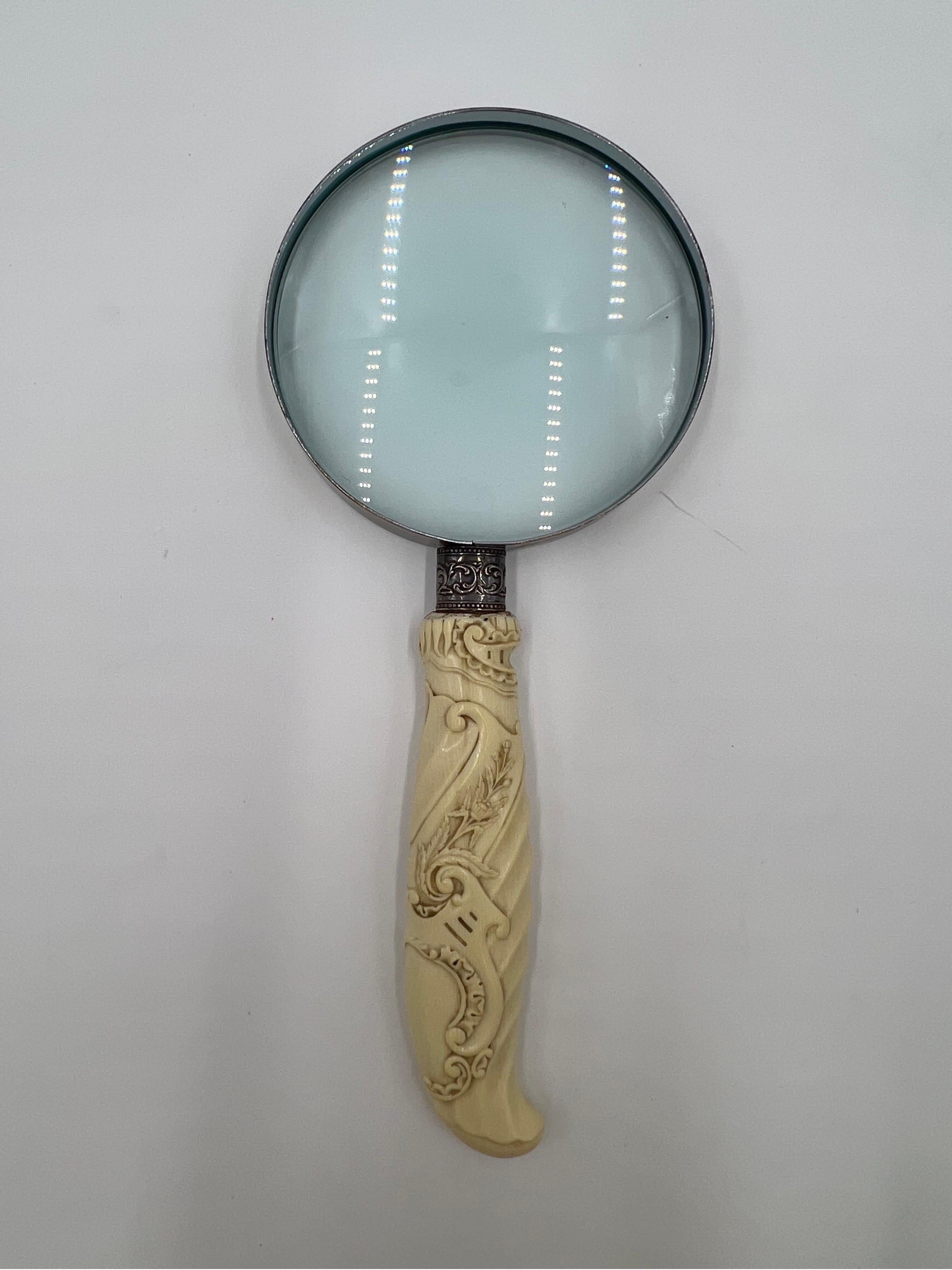 A very fine antique chinese export magnifying glass. The handle constructed from bone and heavily carved with foliage, finger handles and shell style butt. Marked to the silver spacer “sterling”.