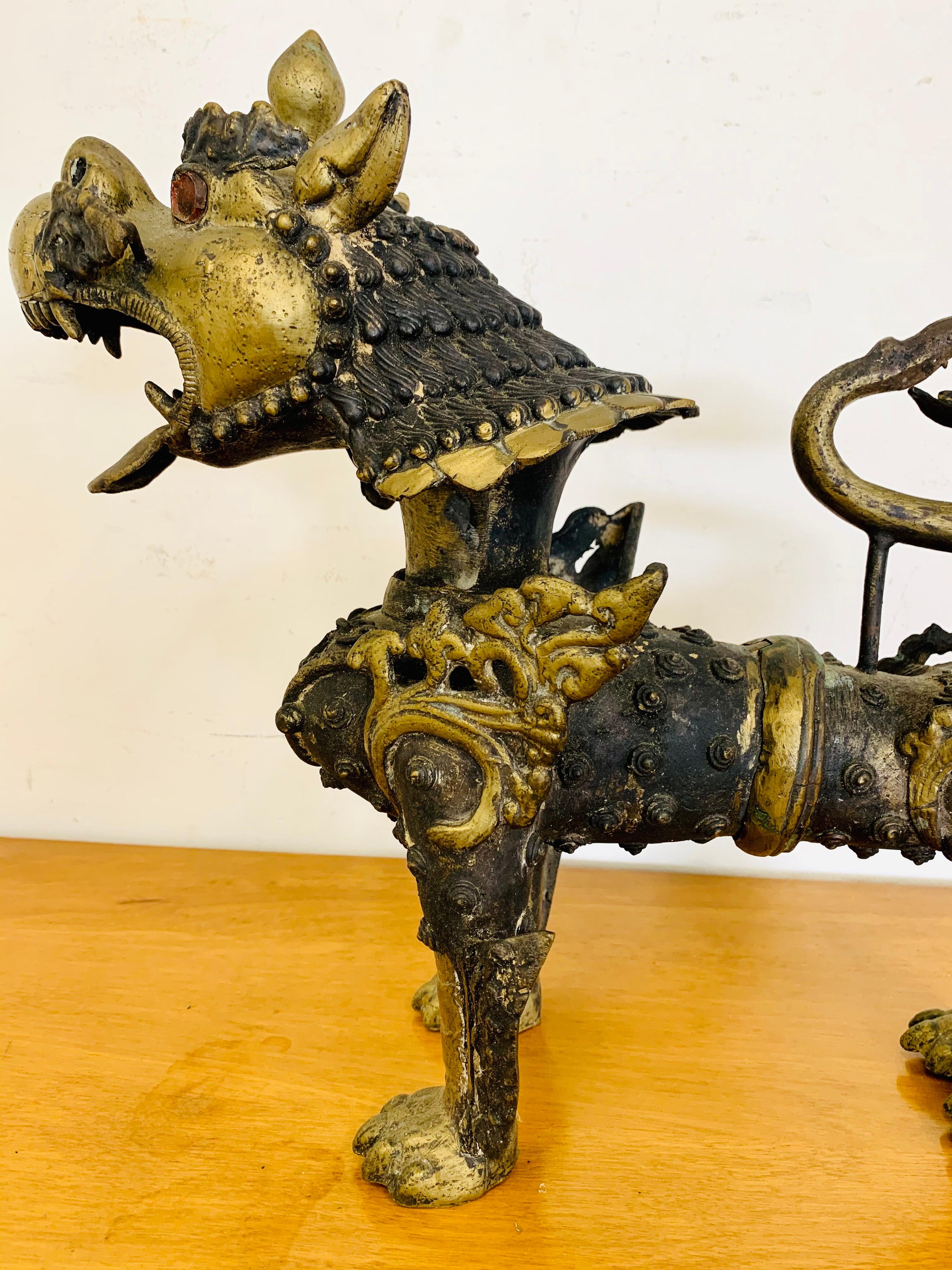 Antique intricately carved heavy cast brass Chinese export foo dogs with extraordinary detail and black painted finish.