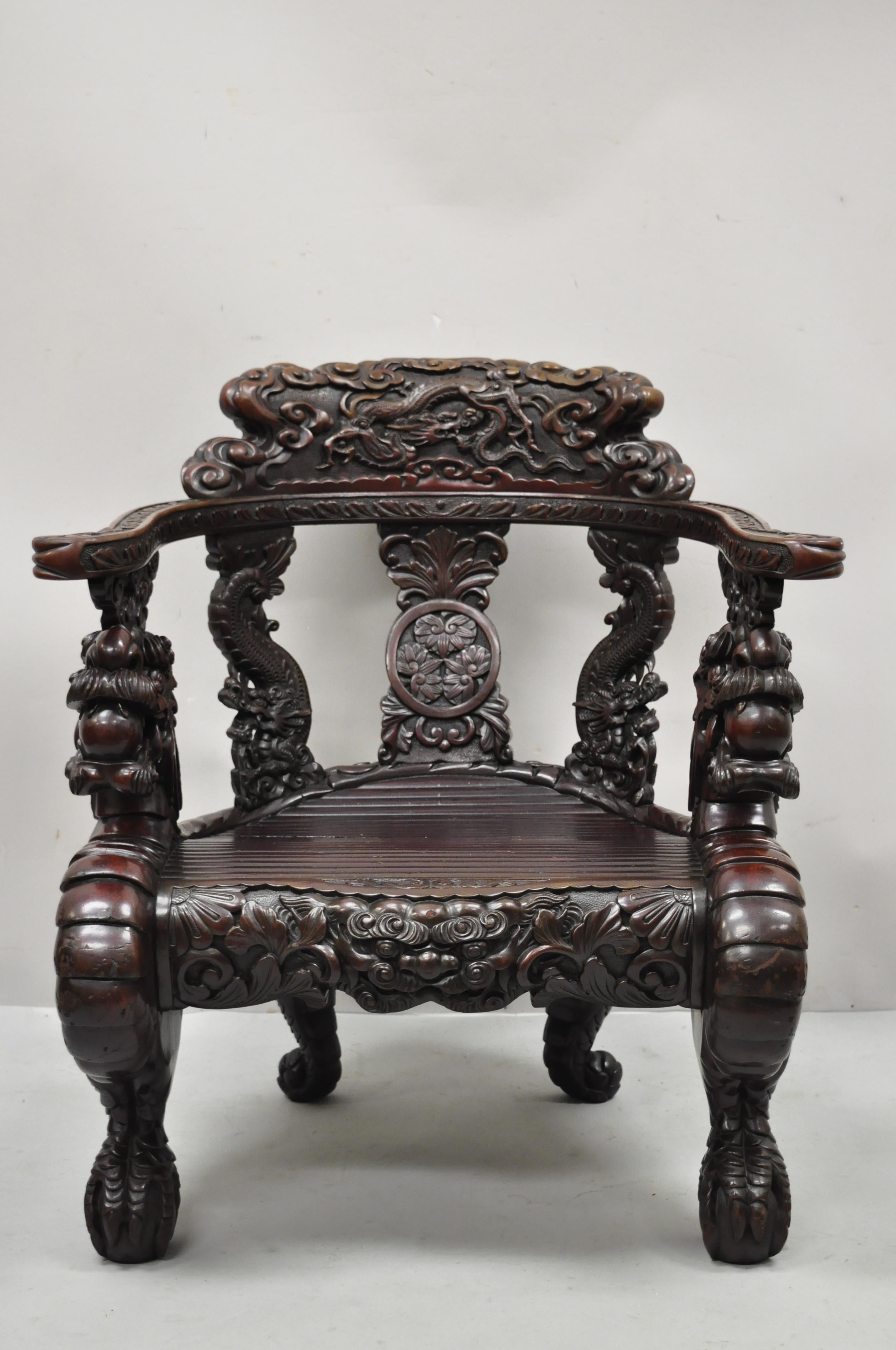 Antique Japanese Meiji Period Dragon Carved Hardwood Lounge Throne Arm Chair. Item features finely relief carved dragons throughout, large dragon and ball and claw legs, remarkably detailed all around, heavy solid wood construction, very nice
