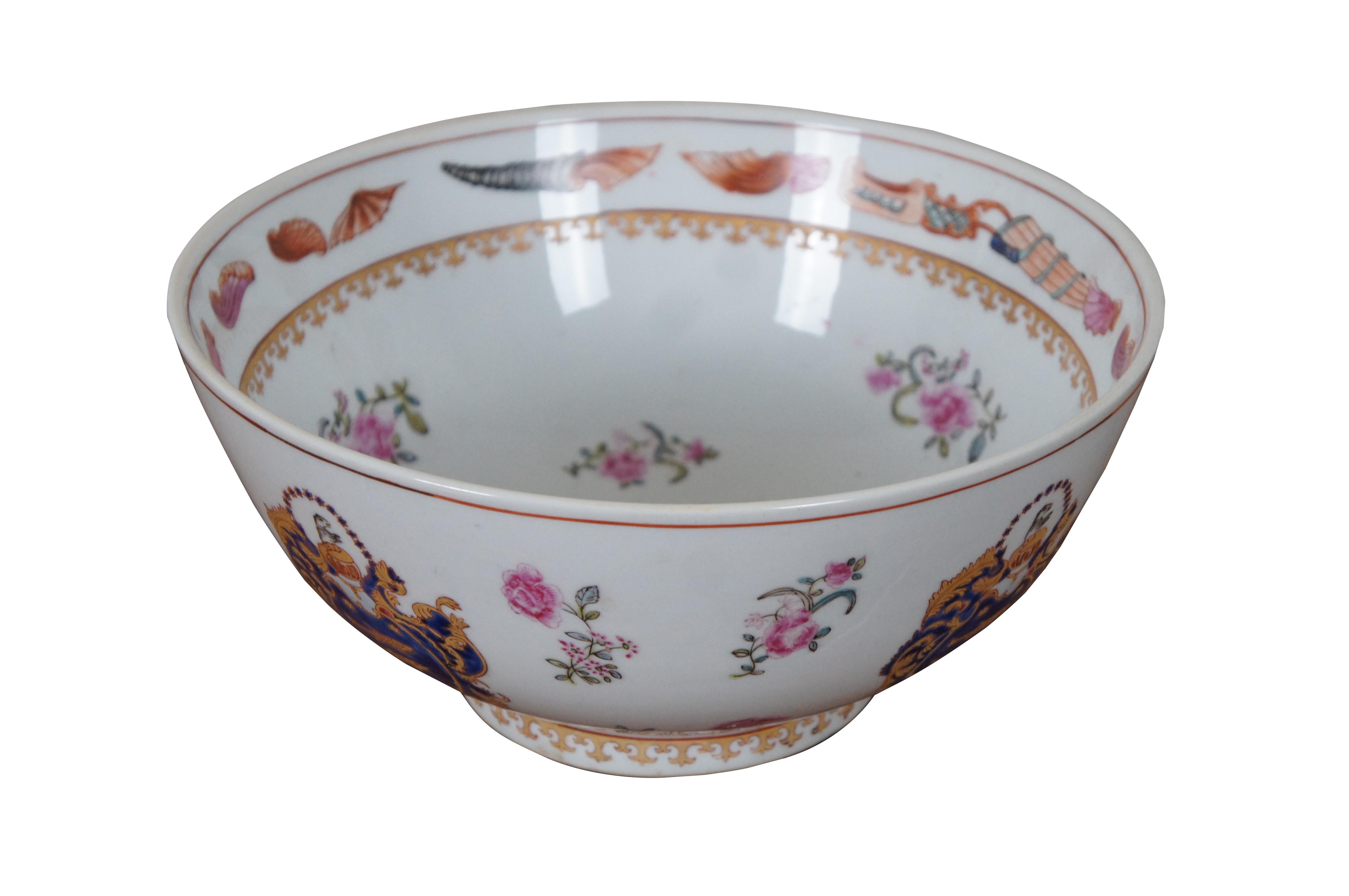 A large and impressive antique Chinese Export porcelain punch bowl featuring a gold and blue armorial coat of arms style crest with fish and dog figures, accented with pink roses, blue stars and an interior border of sea shells.

??????: Made in