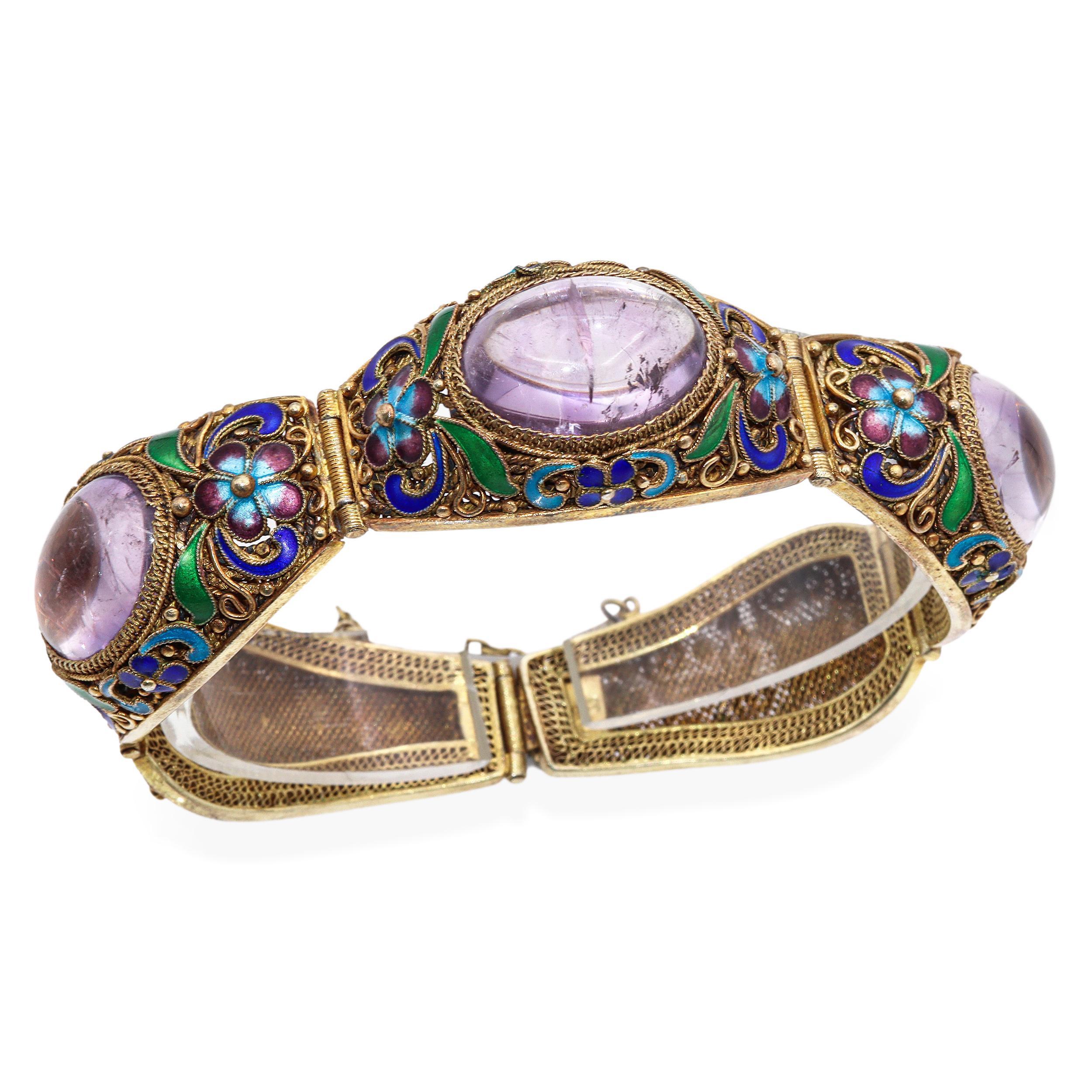 This exquisite antique Chinese Export bracelet is a masterwork of traditional craftsmanship, showcasing vibrant enamelwork, intricate filigree detailing, and richly colored gemstones. The bracelet features panels adorned with large cabochon-cut