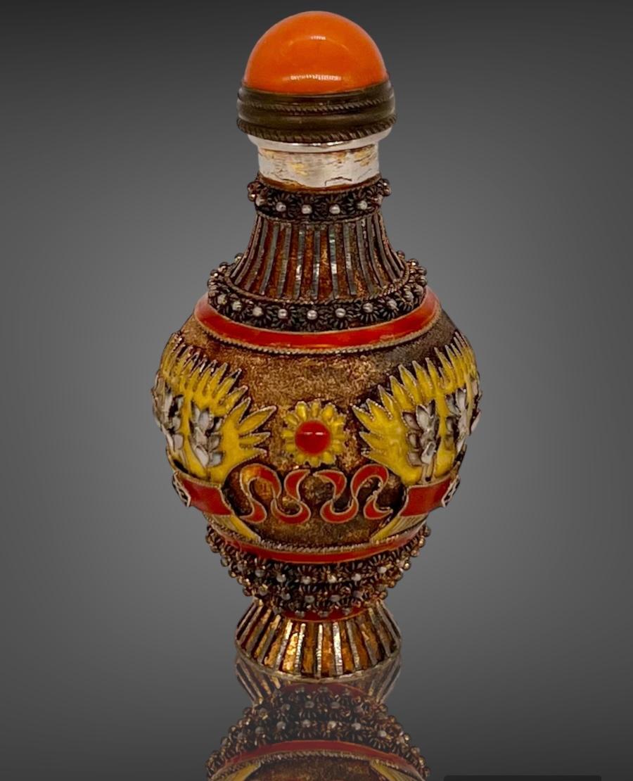 
A Rare Chinese Export Gilt Silver Filigree & Enamel Snuff Bottle.


Republic period of China.



A Nice antique Chinese Export gilt silver filigree snuff bottle with raised enamel decoration in orange, yellow and black and raised silver flowers .