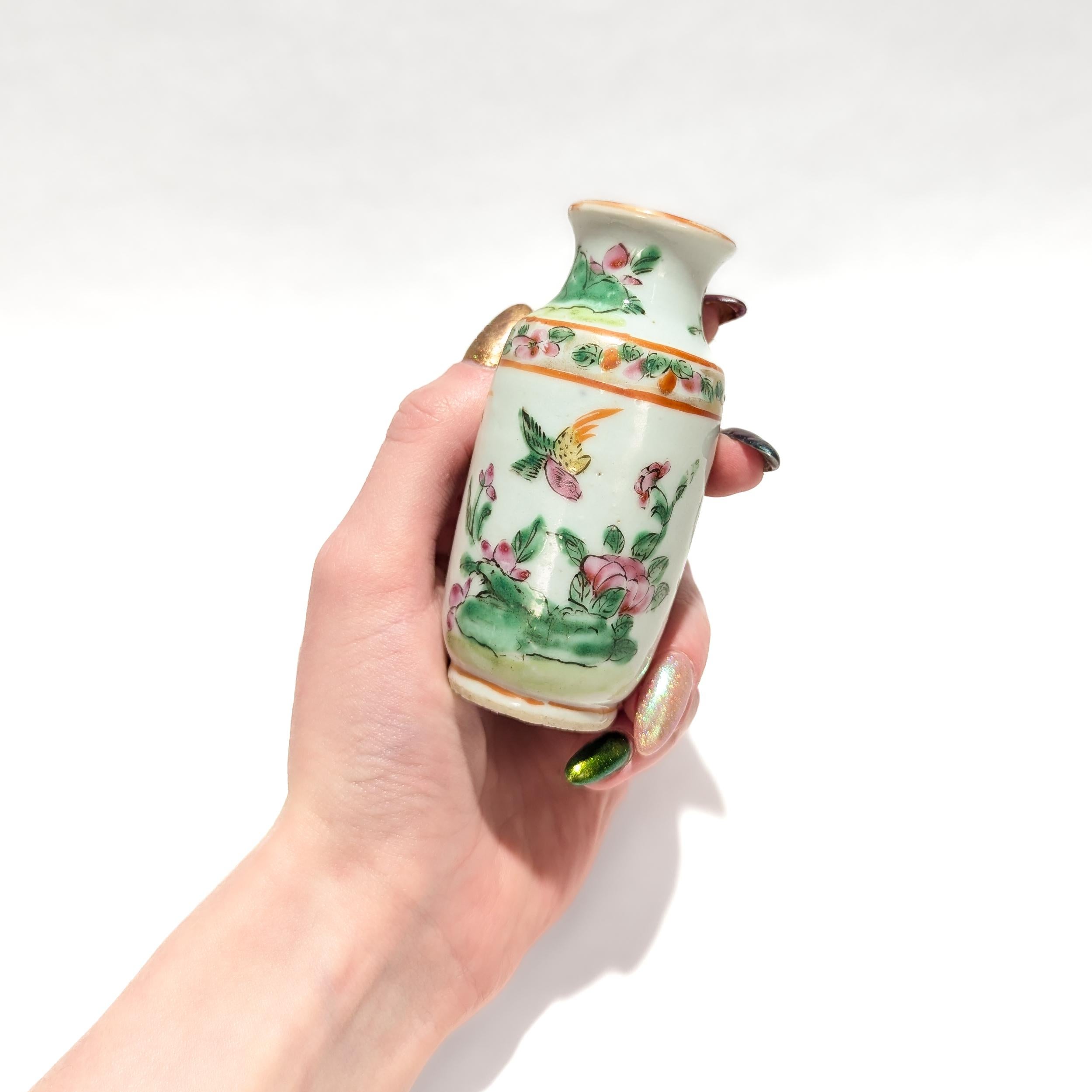 A fine Chinese export porcelain famille rose vase or miniature cabinet vase.

With a white porcelain ground.

Decorated throughout with flora and birds in pink, yellow, green, and orange tones. The shoulder with a ring of painted flower on a gilt