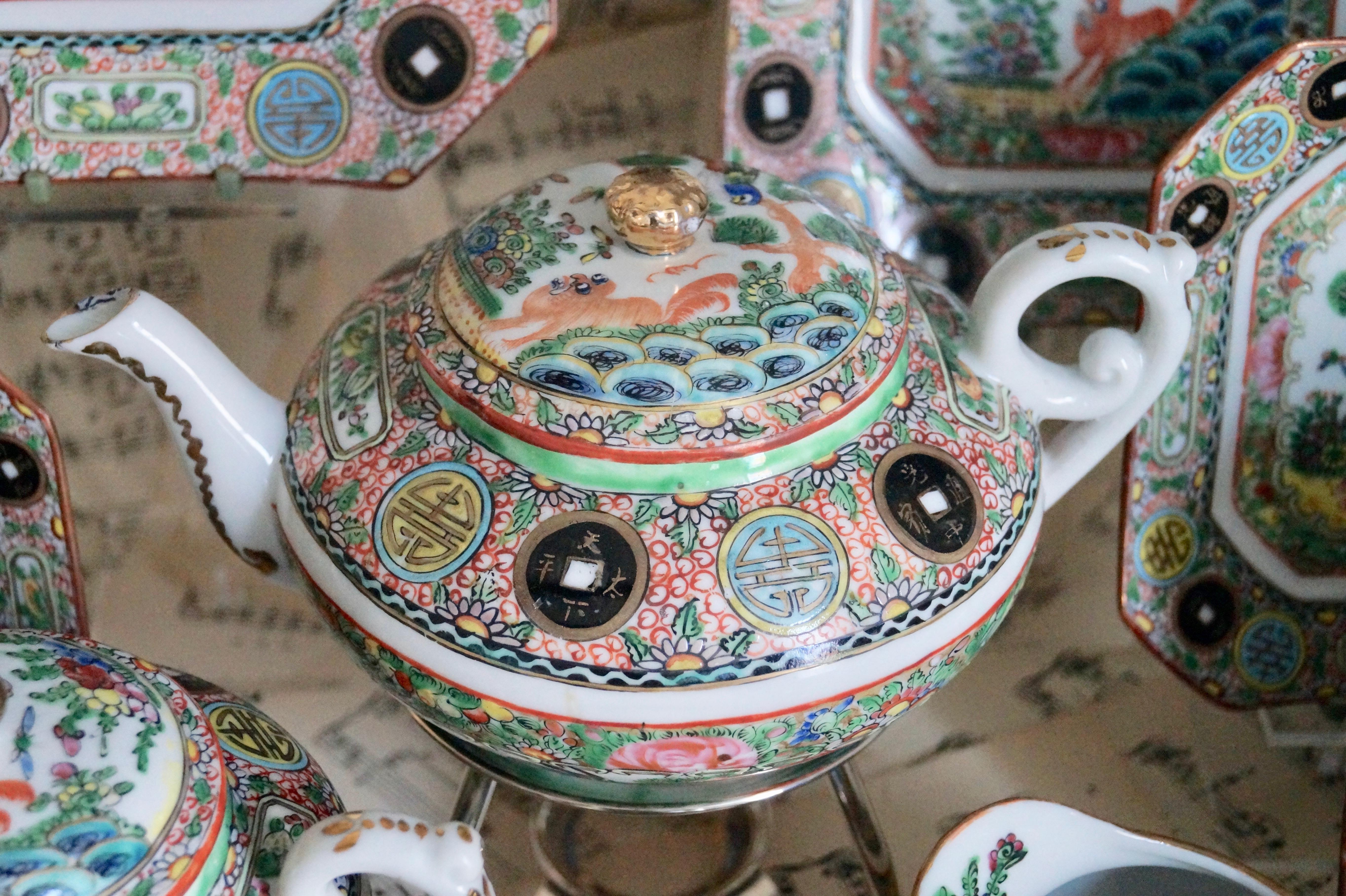 Really beautiful! This antique Chinese tea set for the western export from circa 1880-1900 (Export Porcelain) with Famille Rose decoration of a scene with a Foo dog playing with a bird in the garden with Rocks, Trees, butterflies and plants.

Take