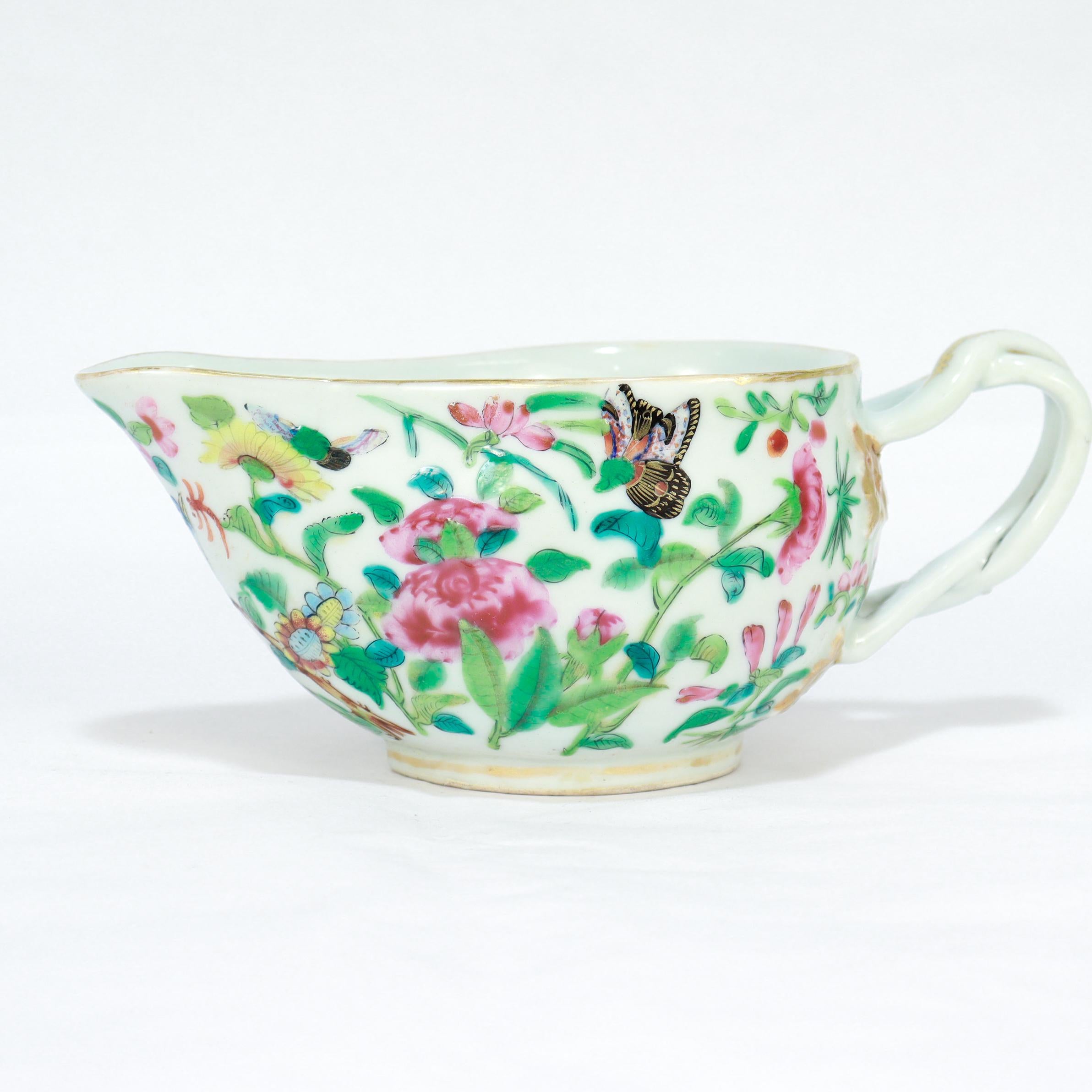 A fine antique Chinese porcelain gravy boat or sauce boat.

In the Famille Rose style.

Decorated with painted scenes of flowers, bugs, and birds. 

The rim, footrim, and handle all have gilt decoration.

Simply a wonderful Chinese Export sauce