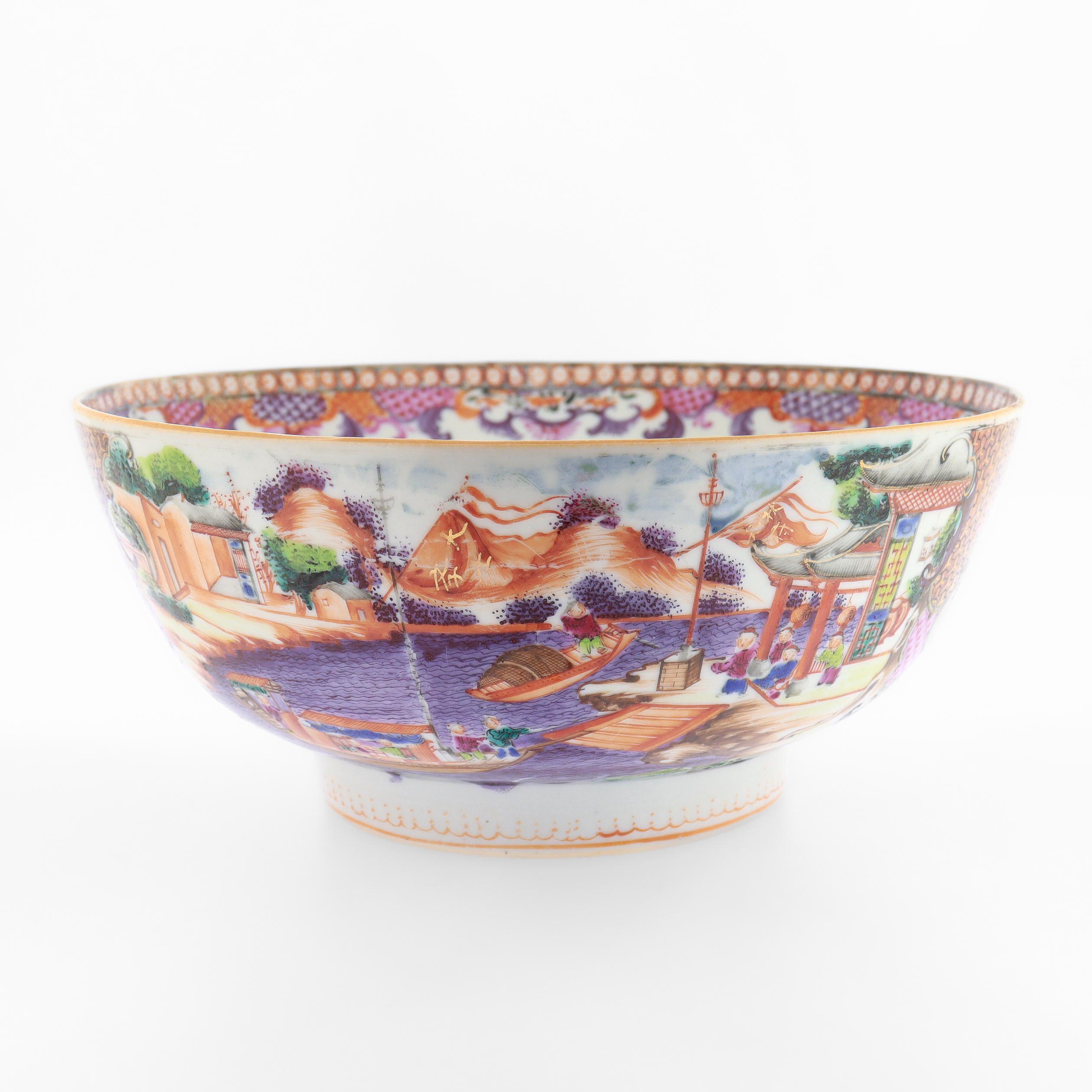 A fine antique Chinese porcelain fruit bowl or small scale punch bowl.

With 'Mandarin Palette' painted enamel decoration.

The exterior decorated with painted village or possibly China Trade scene with buildings, boats, and merchants, along with