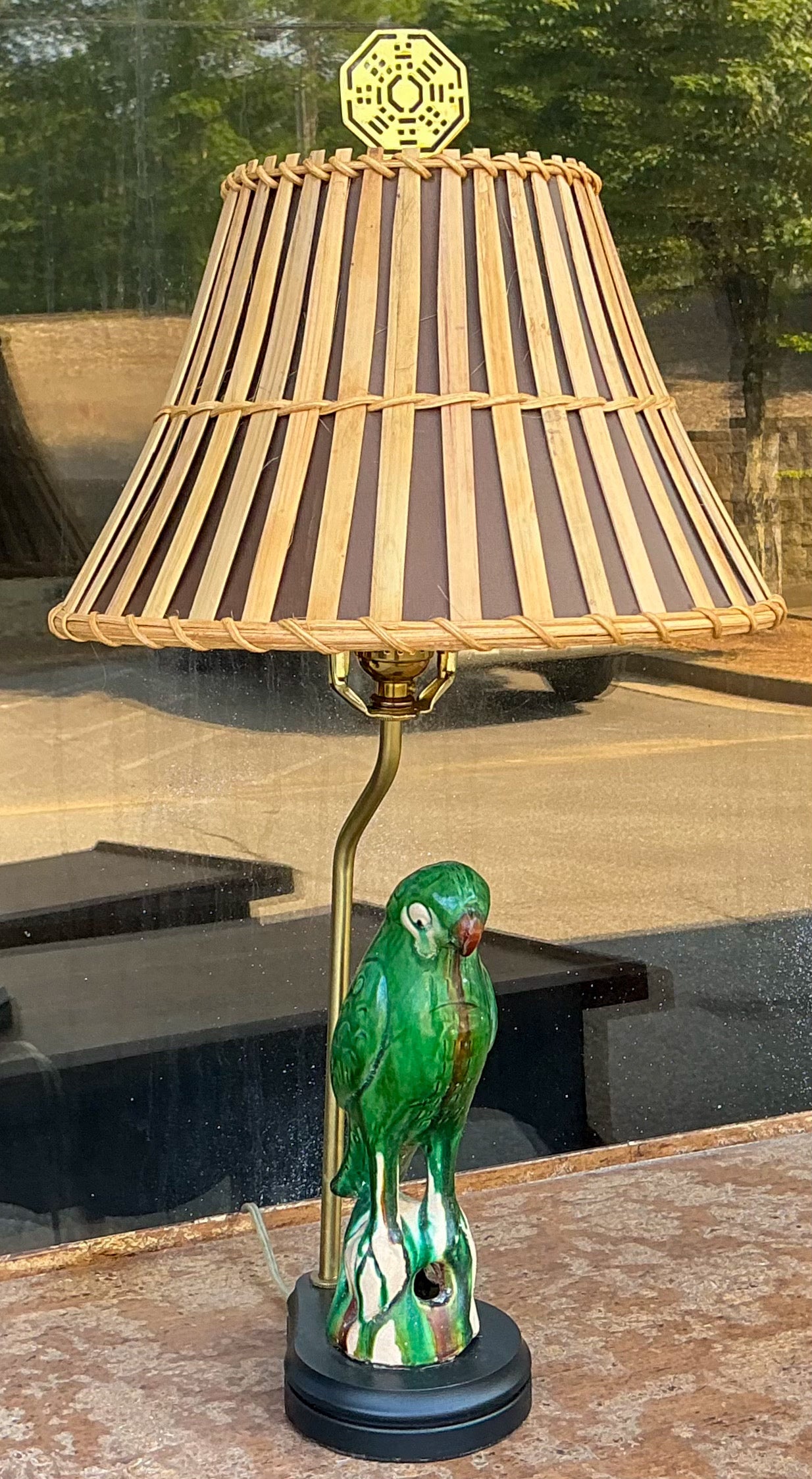 This is a Chinese Export earthenware parrot roof tile that has been converted into a lamp. The bamboo shade is new. It measures 12”D x 7”H. The wrong is new as well. 