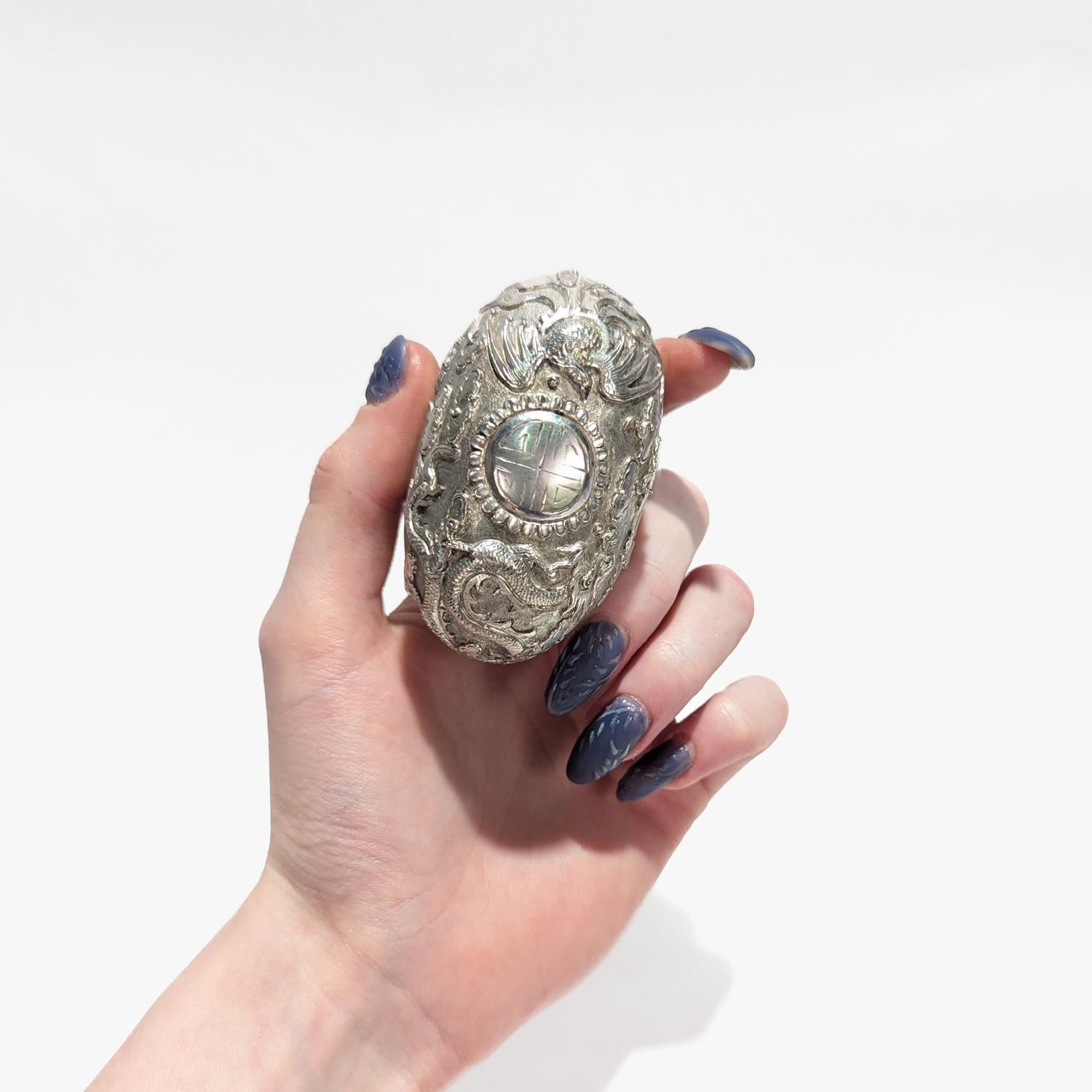 A fine antique Chinese export repousse silver box.

Decorated to the lid with a central stylized depiction of the character 壽 (shòu, longevity) stylized like the Sun amidst the clouds with a phoenix to its left and a dragon to its right. 

Of