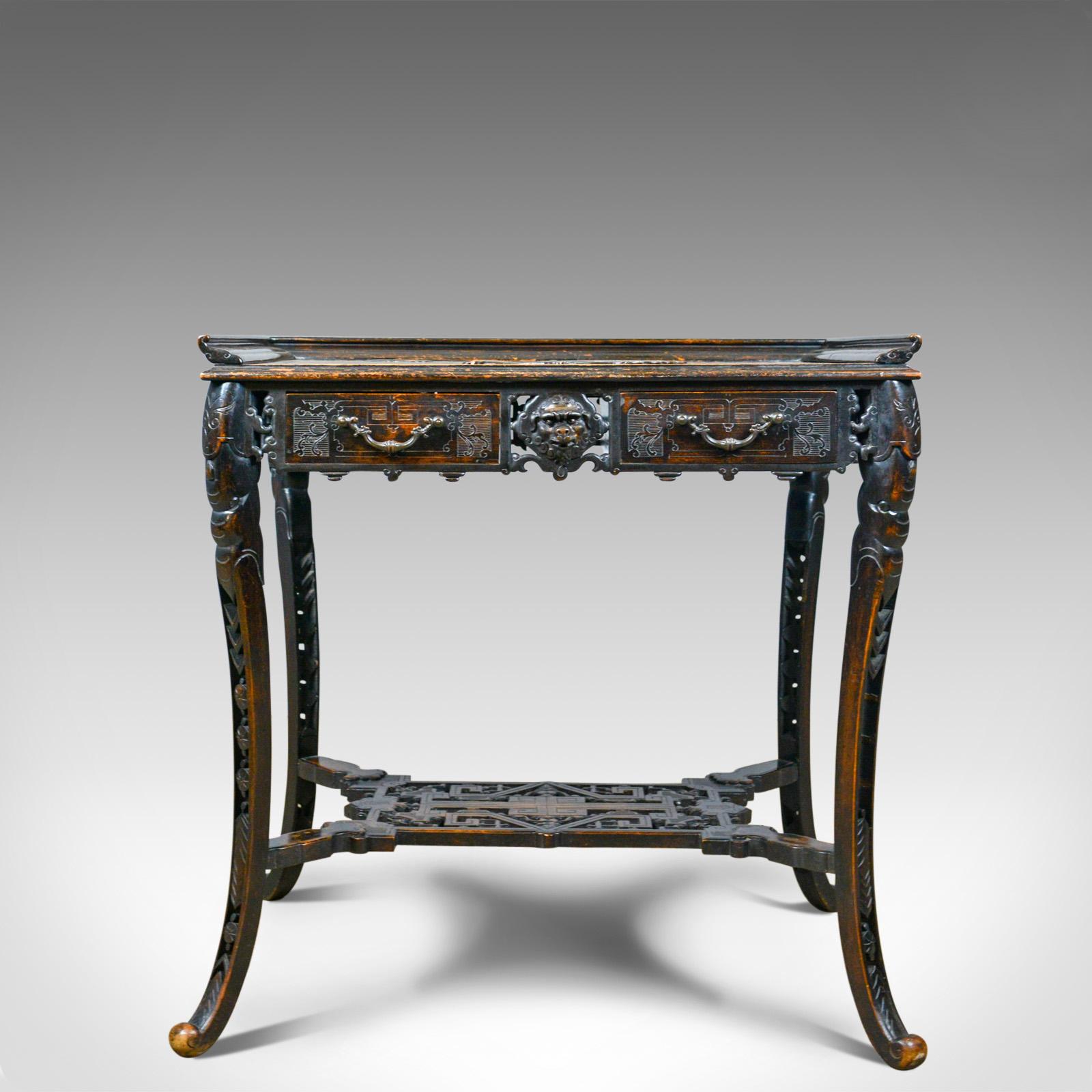 This is an antique Chinese export side table, a carved oriental table dating to the late Victorian period at the turn of the 20th century, circa 1900. 

In good proportion and of quality craftsmanship
The dark stained mahogany displays