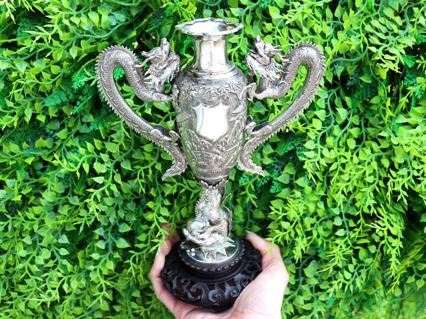 An exceptional, fine and impressive antique Chinese Export Silver and cherry wood based vase; an addition to our ornamental Asian silverware collection.

This impressive antique Chinese Export silver vase has a tapering cylindrical rounded form with