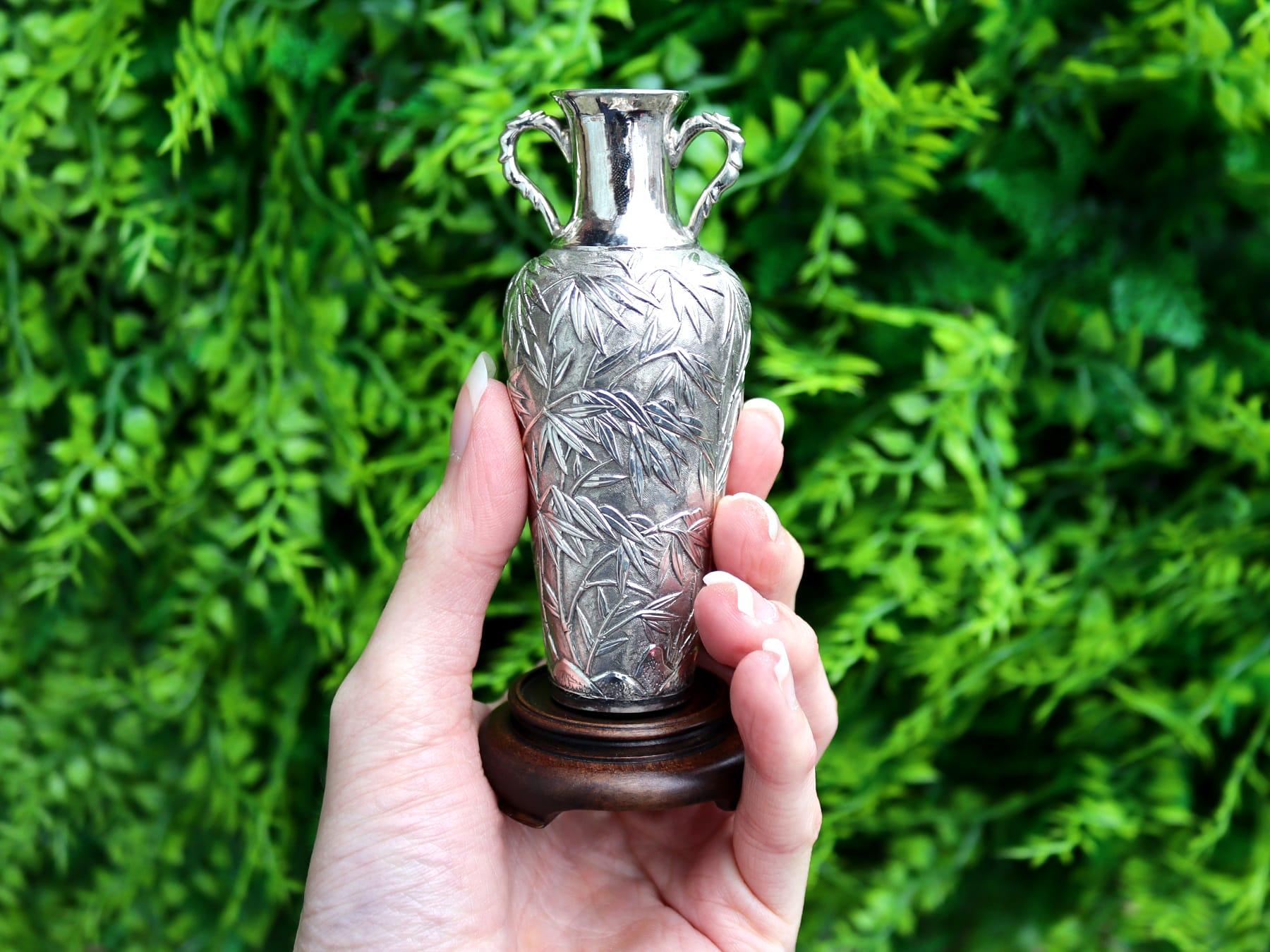 An exceptional, fine and impressive pair of antique Chinese export silver and cherry wood based vases; an addition to our ornamental silverware collection

These impressive antique Chinese export silver vases have a tapering cylindrical rounded form
